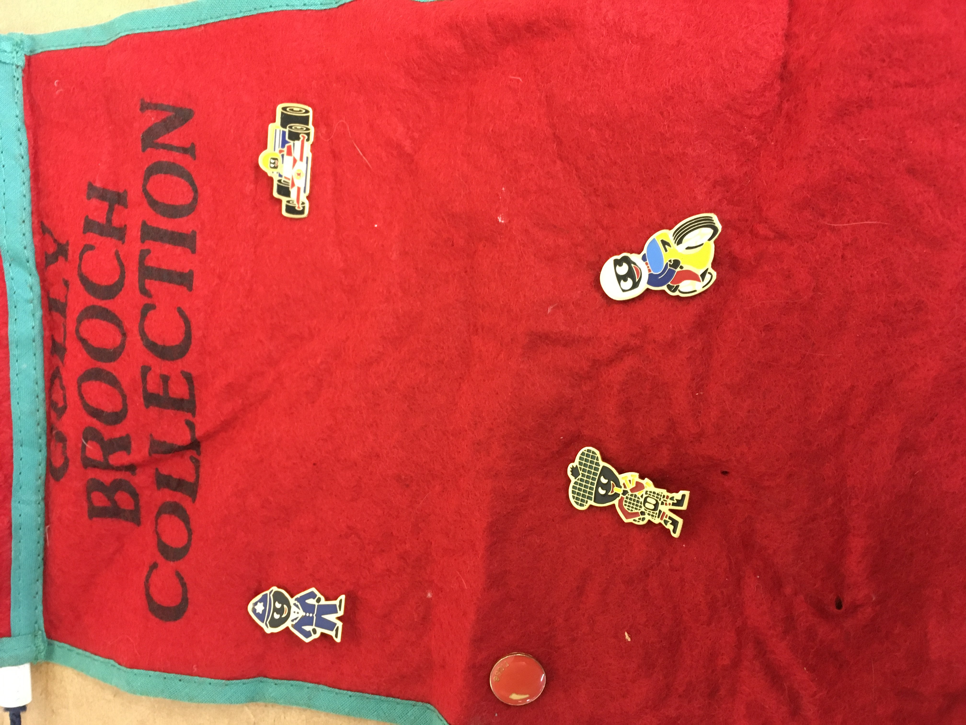 Four golly badges on the collectors cloth .