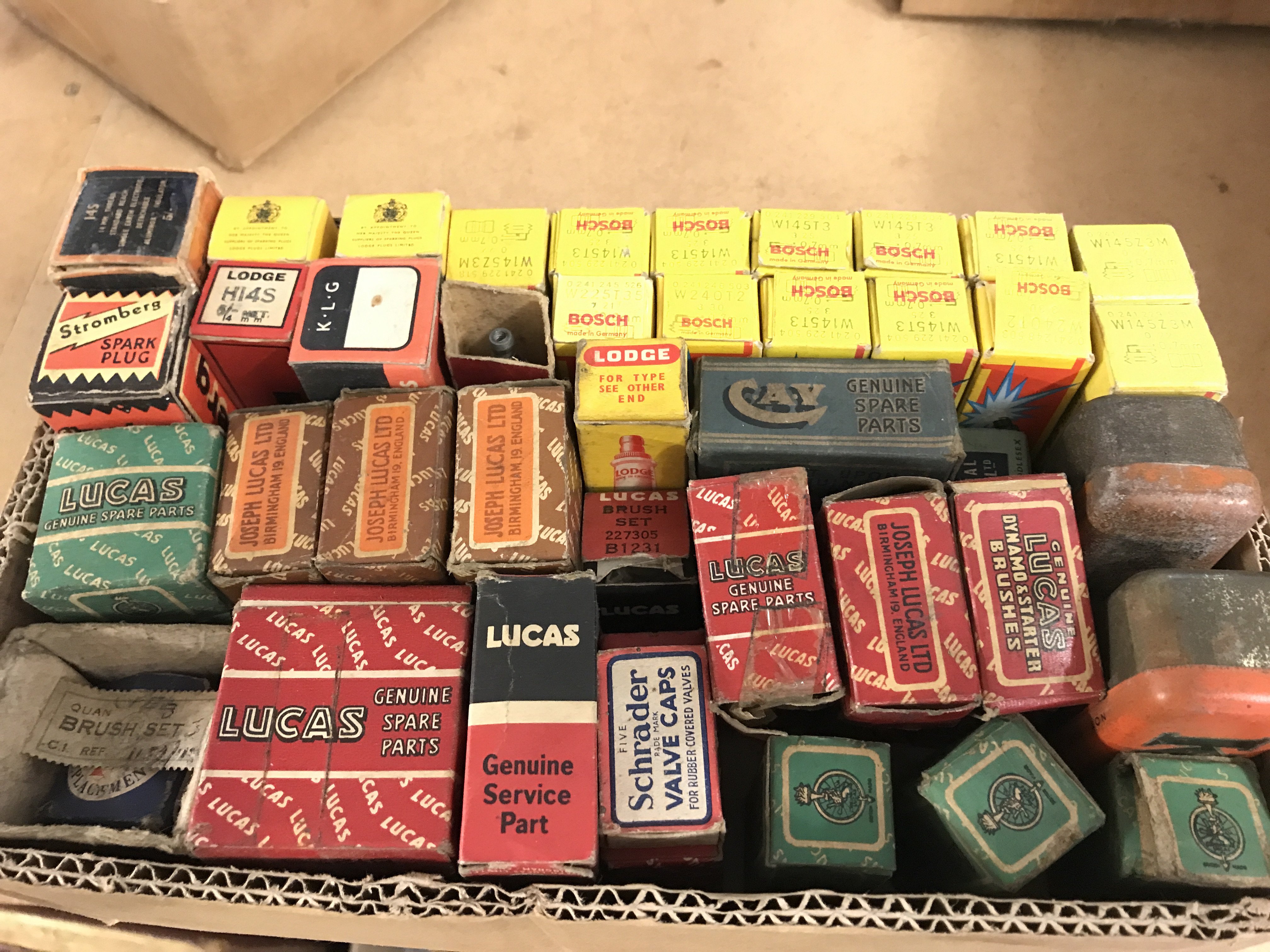 A box of vintage motoring accessories including spark plugs, bulbs etc . All boxed . This lot cannot be posted