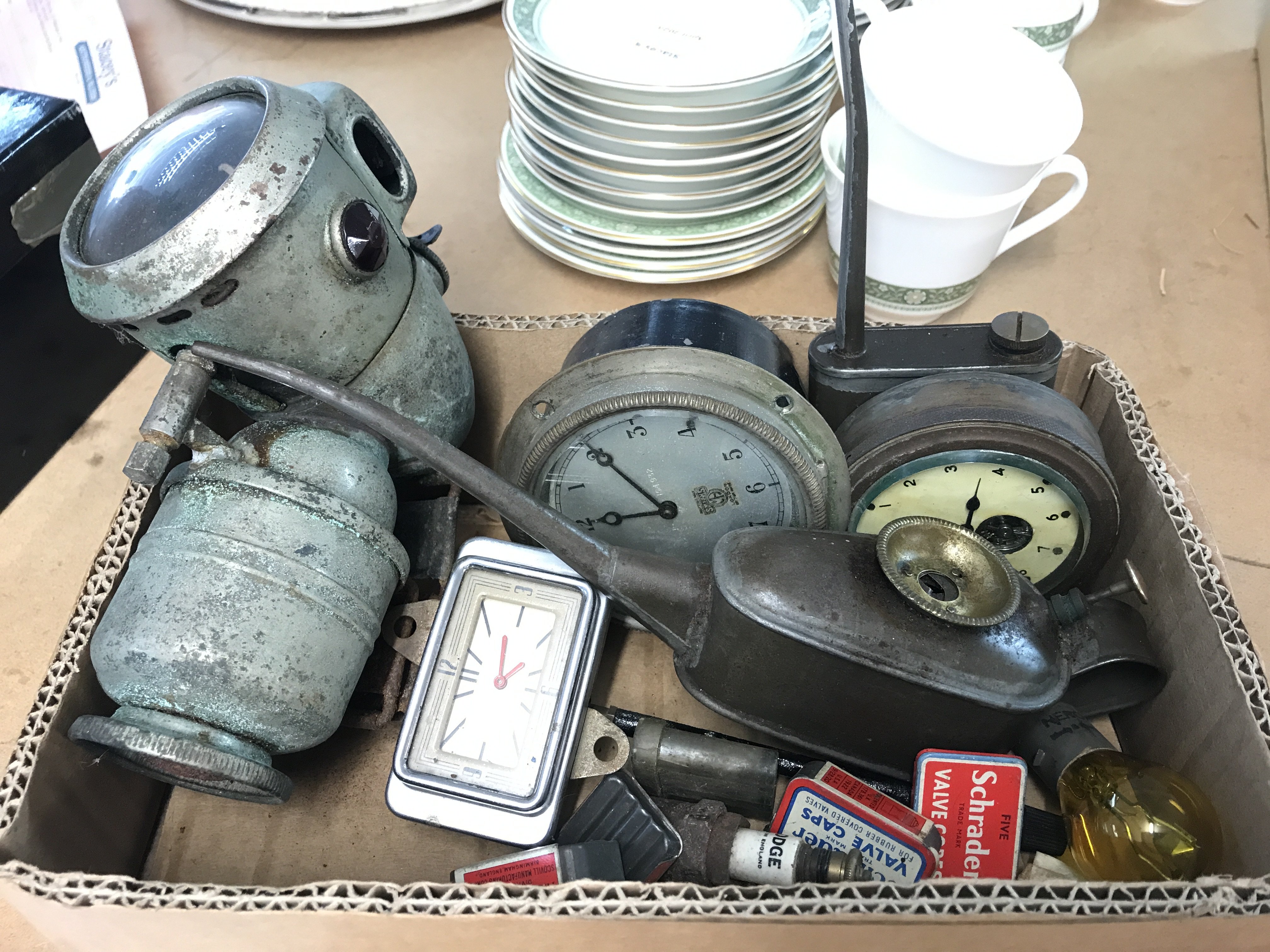 A box containing three vintage car clocks and other items . This lot cannot be posted