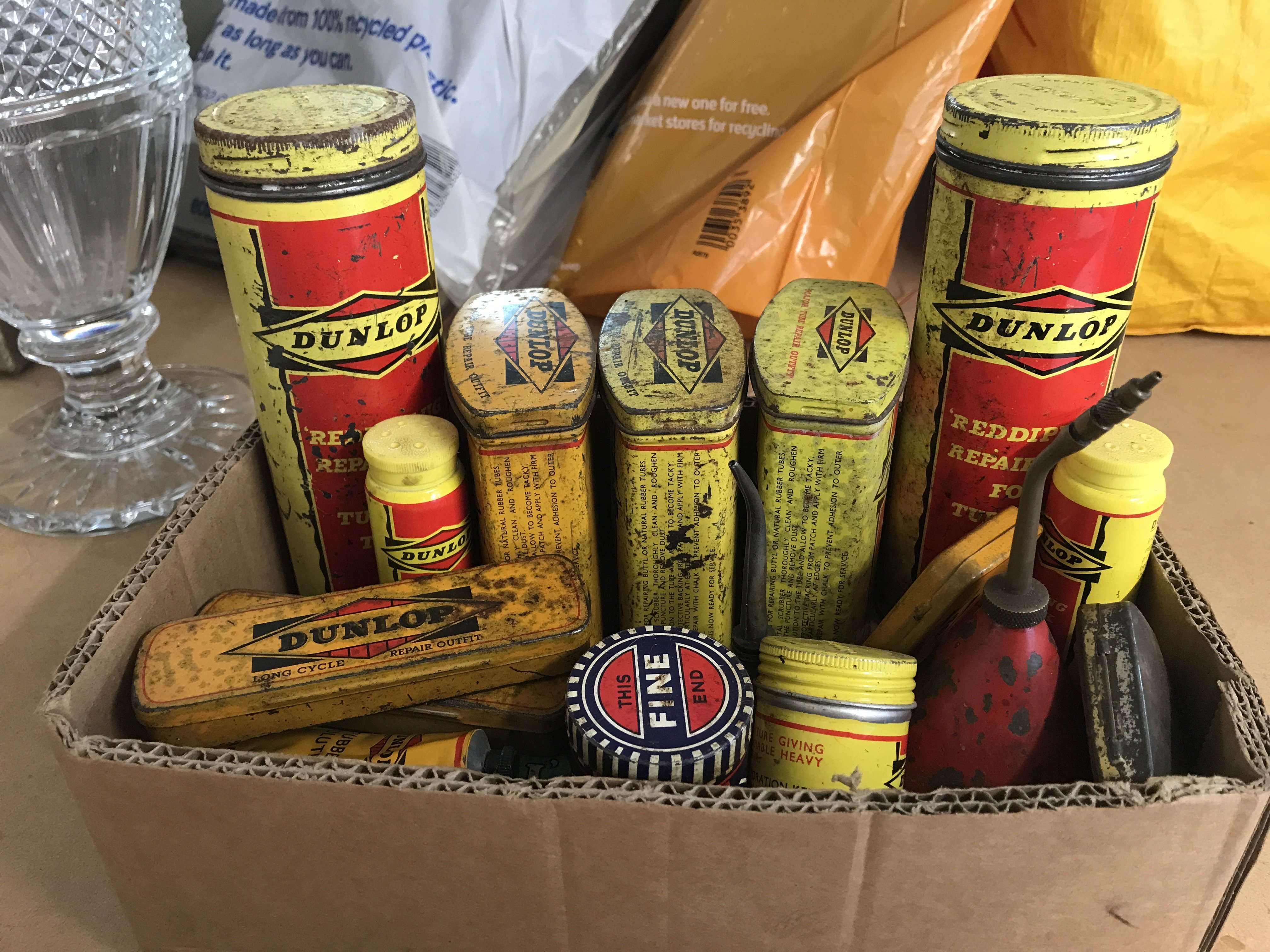 A box containing vintage Dunlop and other tins. Postage category B