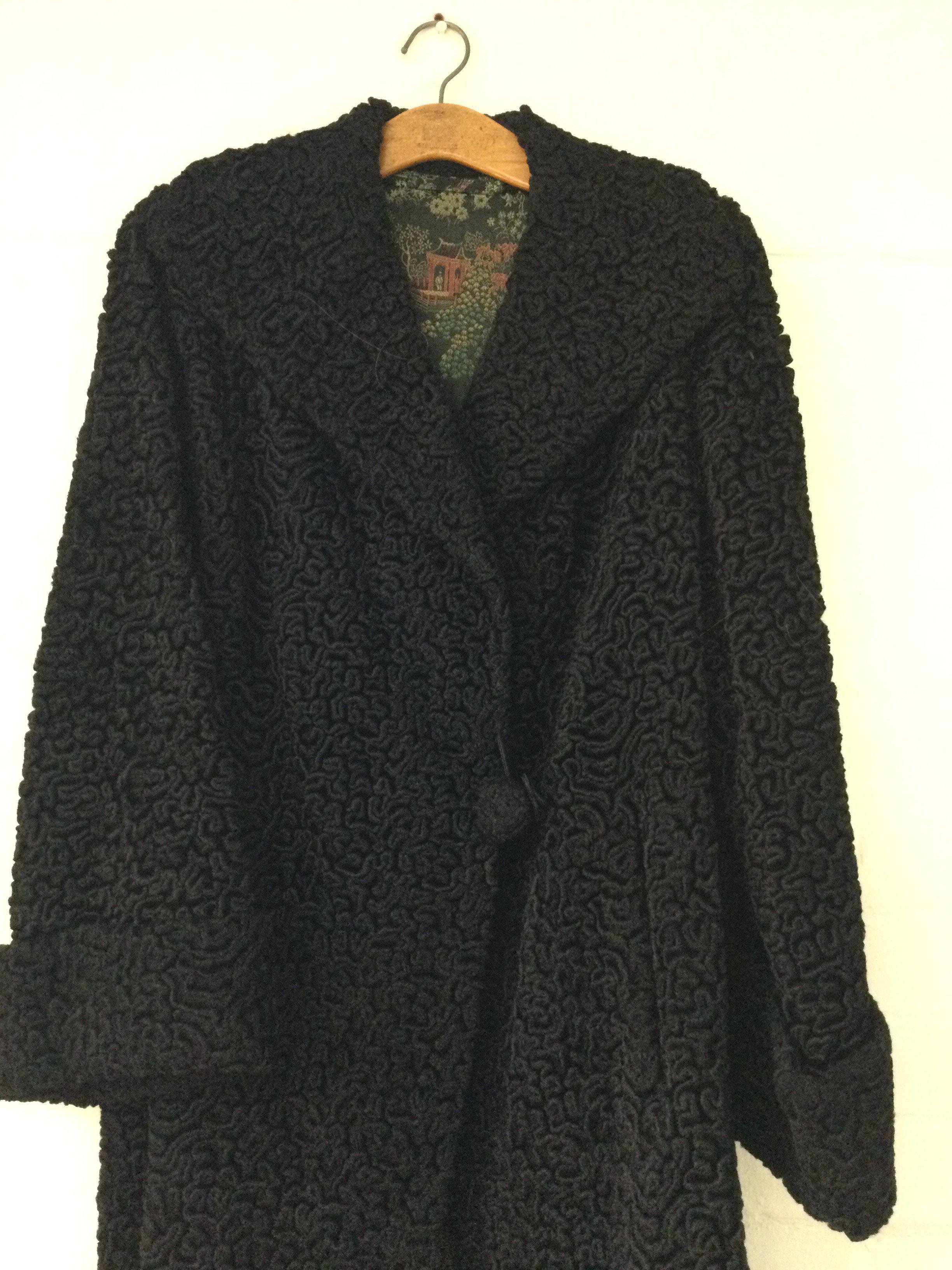 A vintage Astrakhan coat with oriental inner lining l
