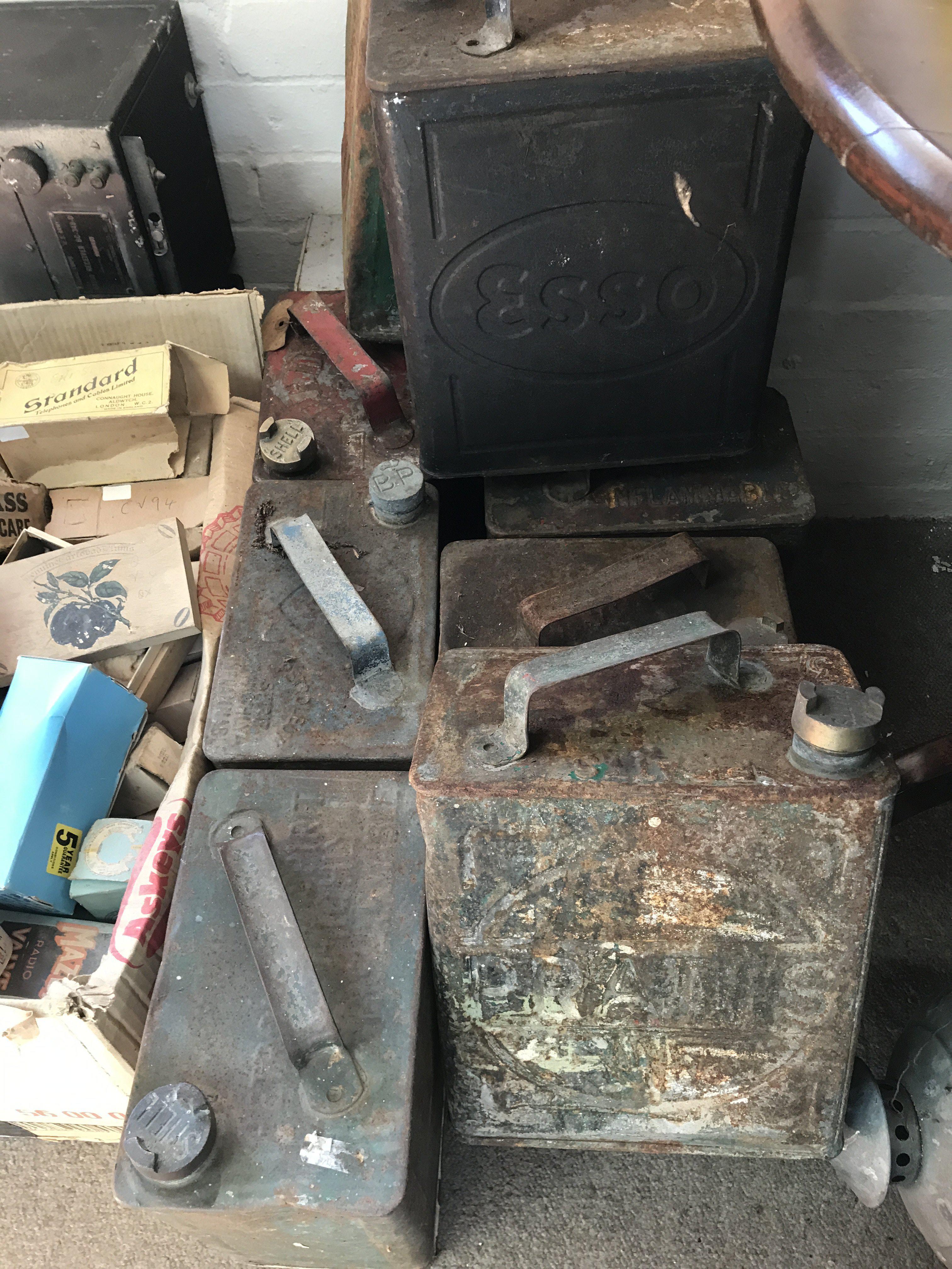 A collection of nine oil cans .