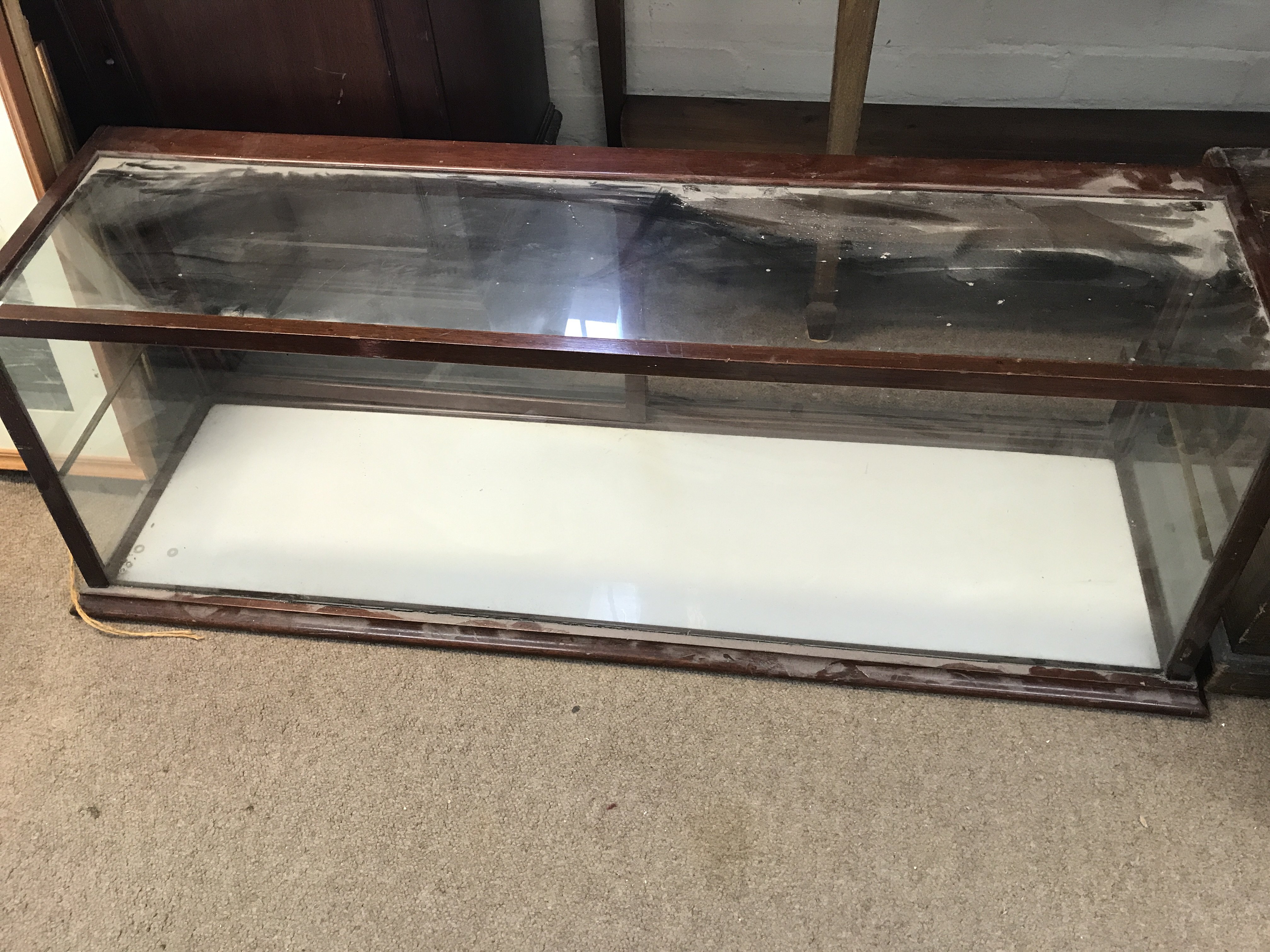 A table top display cabinet with two sliding doors ( no shelves) . 110 cm 30 cm .