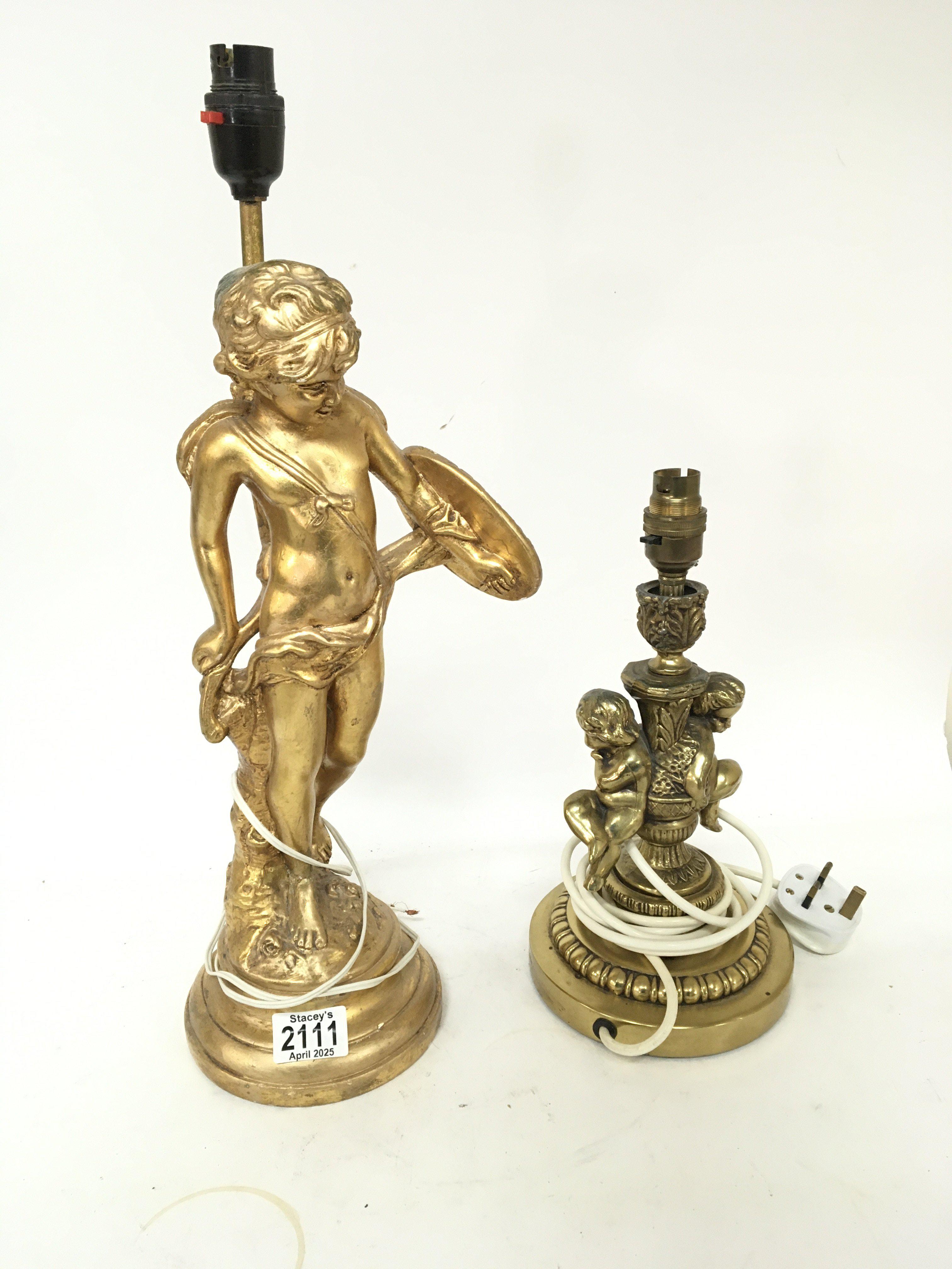 Two table lamps a brass lamp surmounted with two putti and the other a Neo classical figure (2)