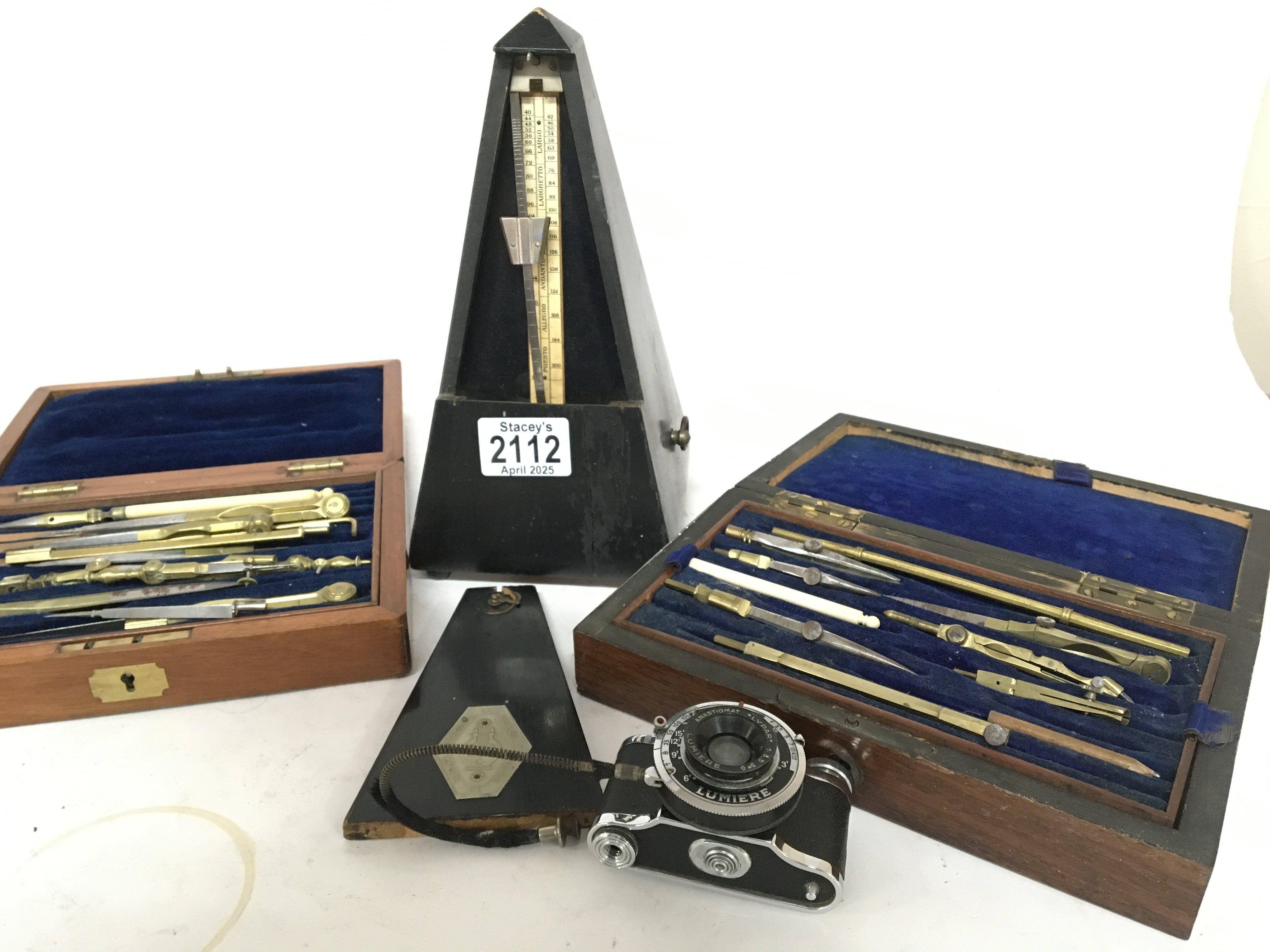 A Swiss made Metronome two cased sets of vintage architects drawing instruments and a Vintage miniature ELJY Lumiere camera (4)