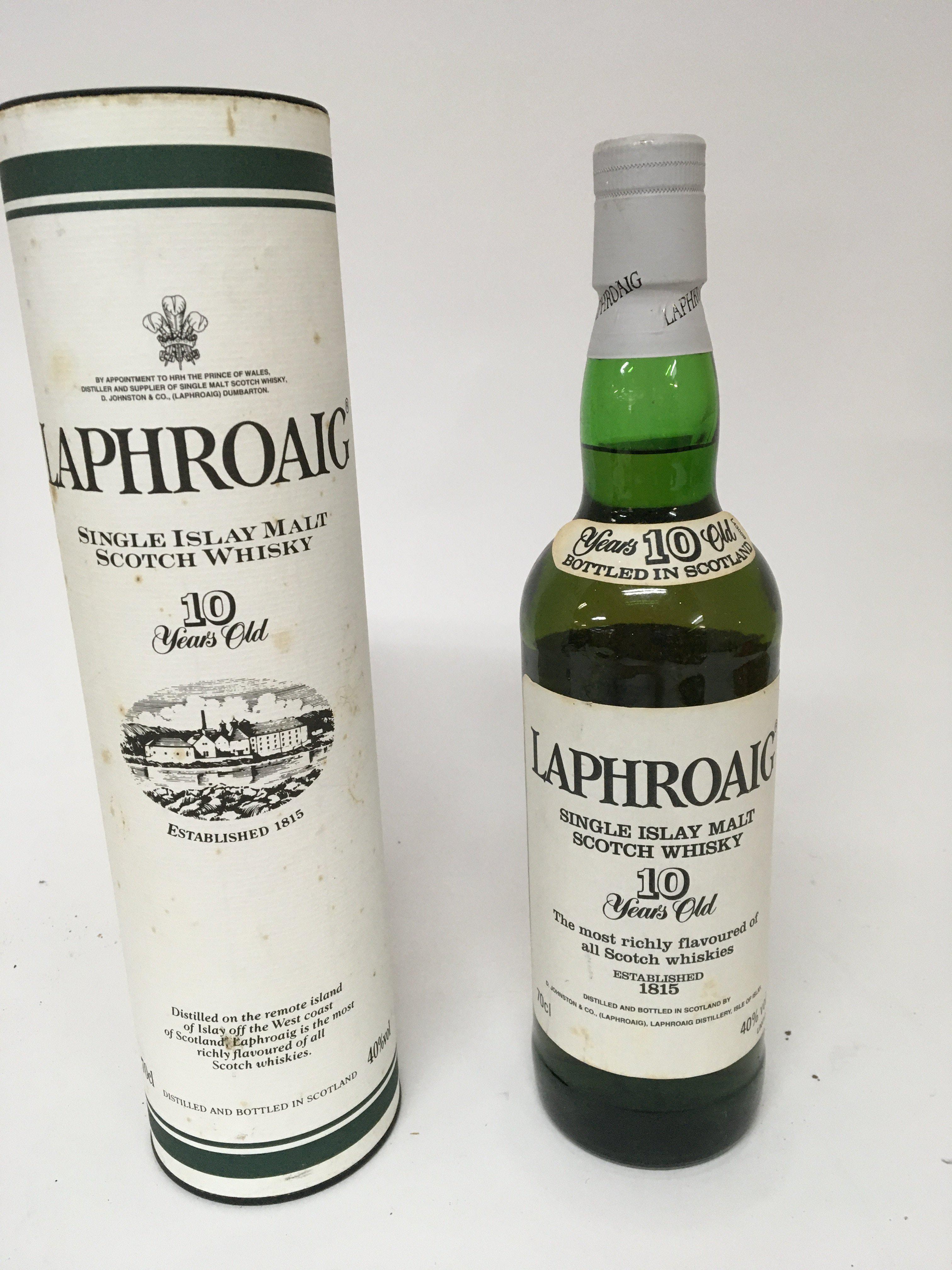 A bottle of pre Royal Warrant Single Malt Laphroaig Whiskey 10 year old and one other bottle of Laphroaig 10year Single malt in a presentation tube with Royal Warrant for the Prince of Wales both bottles 70cl (2)