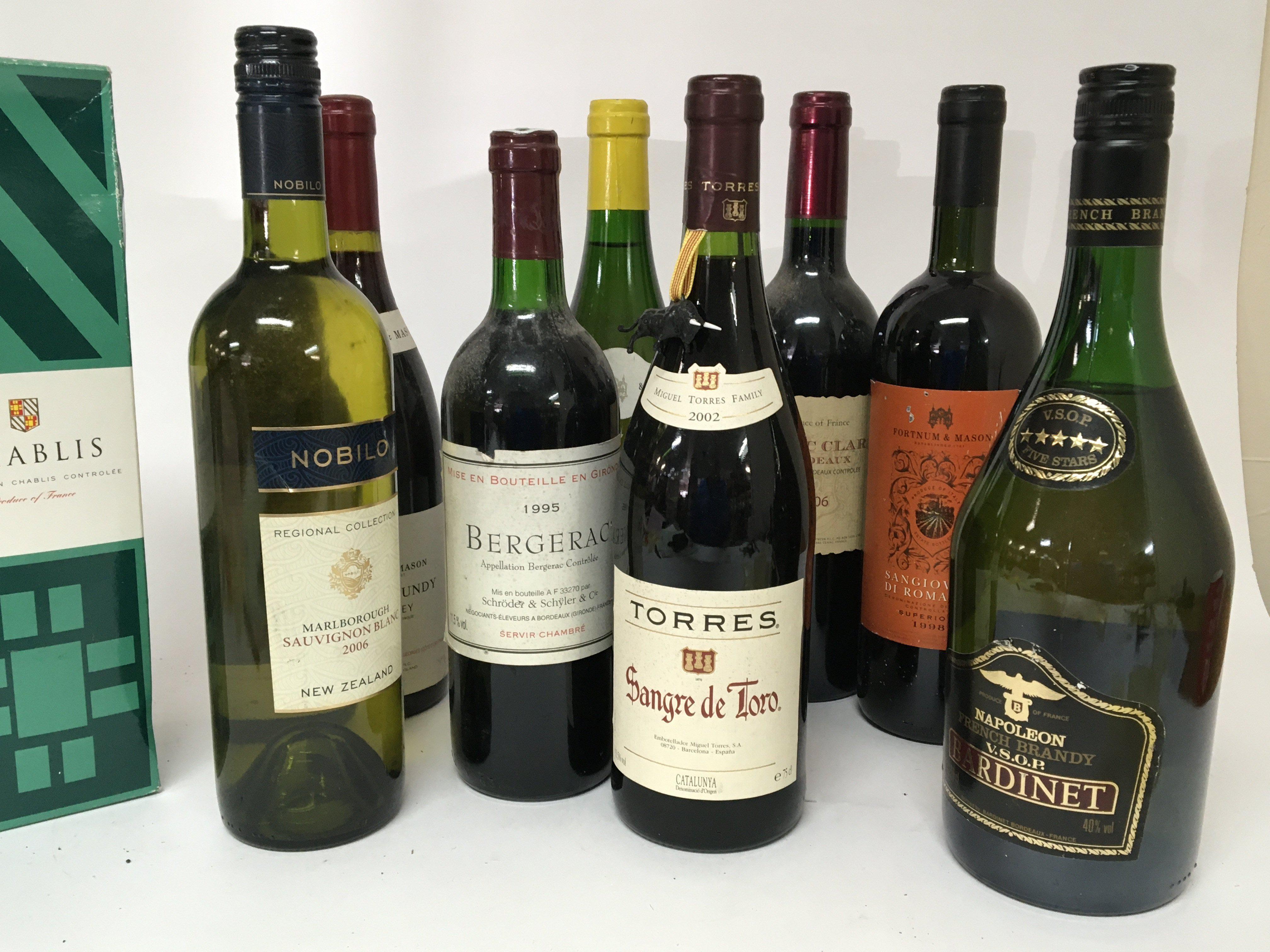 A collection of wines including a 1995 Bergerac 1994 Red Burgundy 2006 Classic Bordeaux a bottle of French Brandy (9)