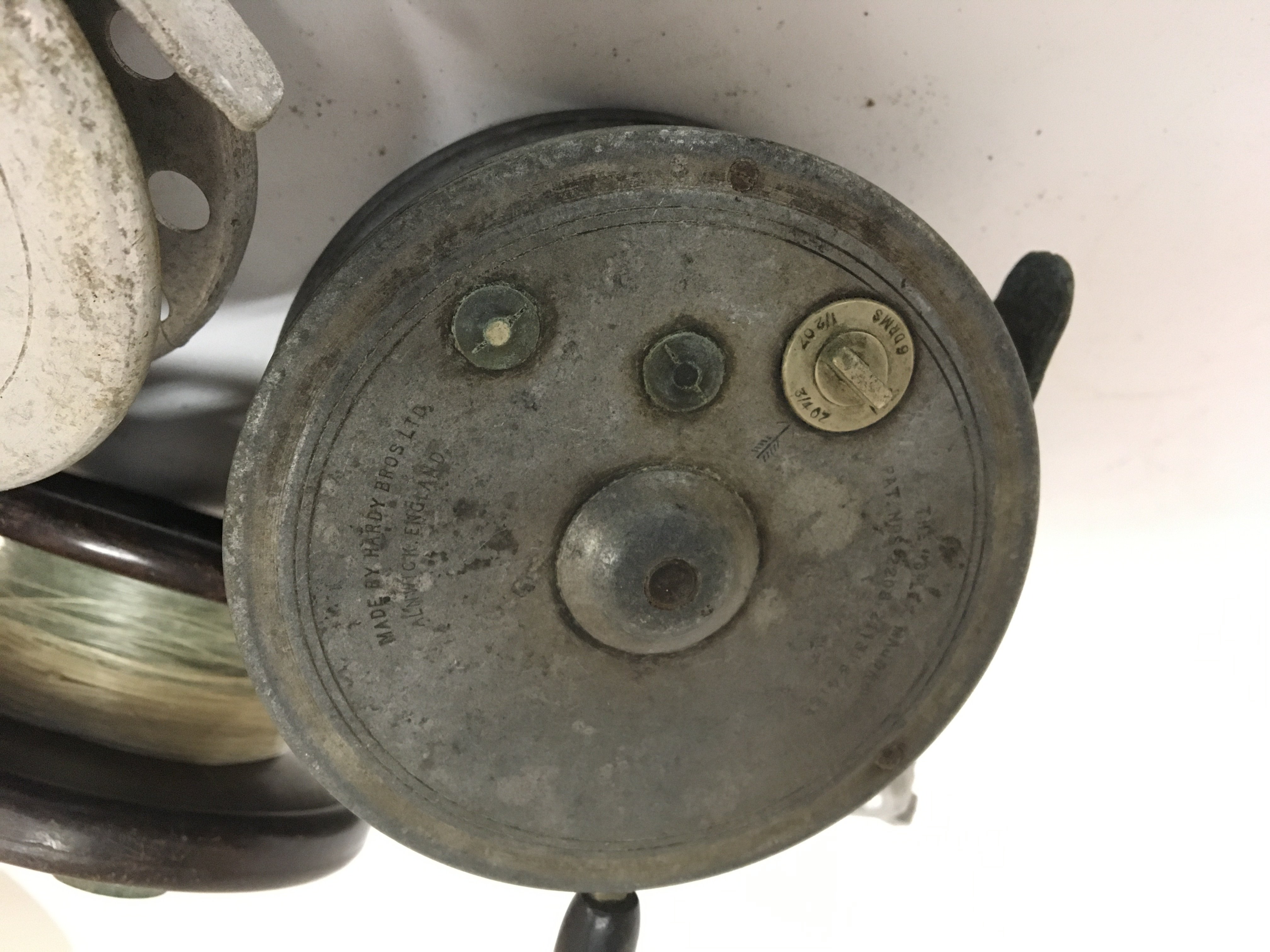 A Vintage Hardy Brothers of Alnwick fishing reel The Silex Major other vintage fishing reels a box of fishing tackle and oddments and split cane fishing rod