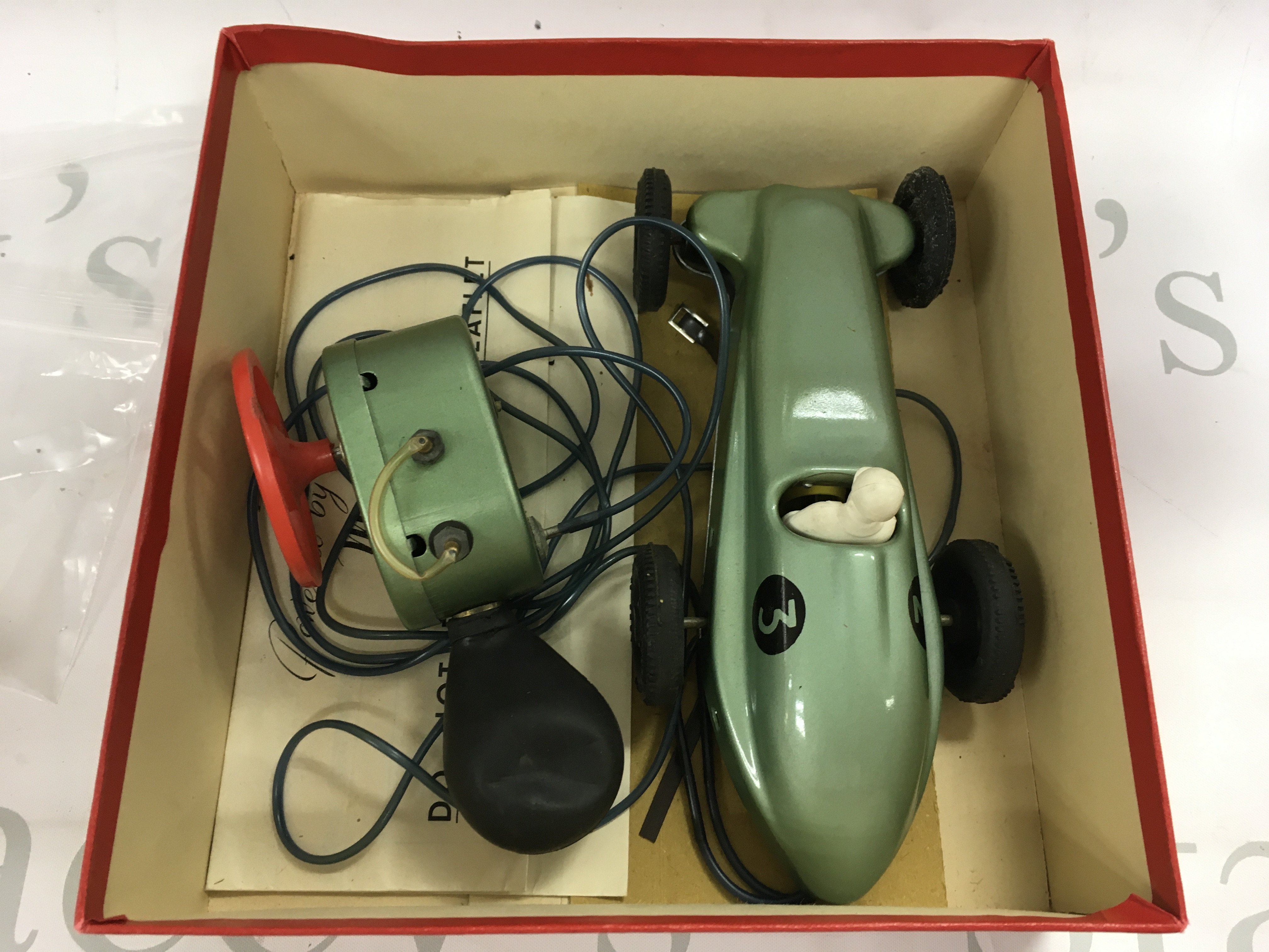 A vintage phantom II motor matic car in box with other playworn cars.
