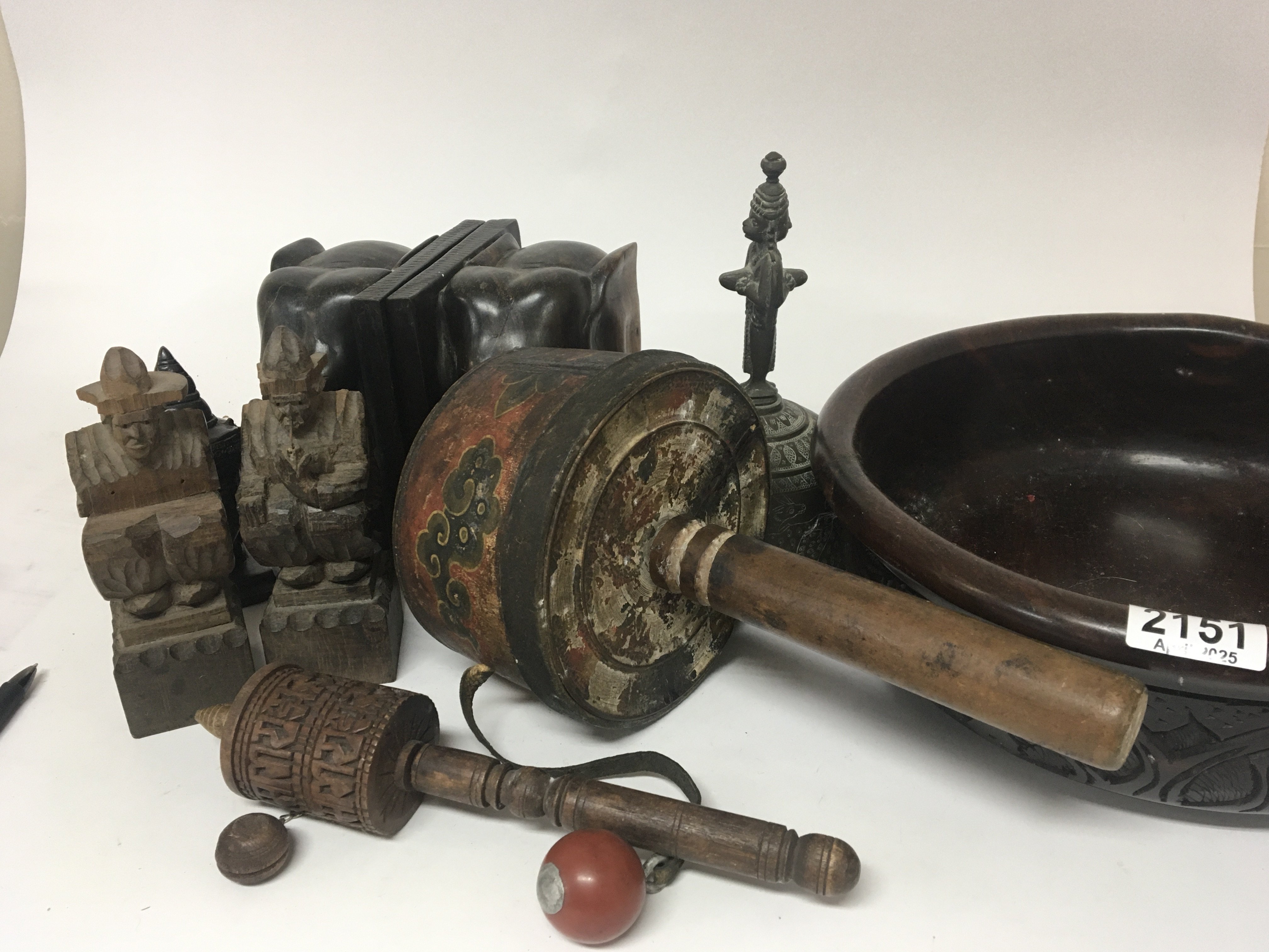 Two old Tibetan prayer wheels a carved treen bowl elephant bookends a Tibetan hand bell and other oddments.
