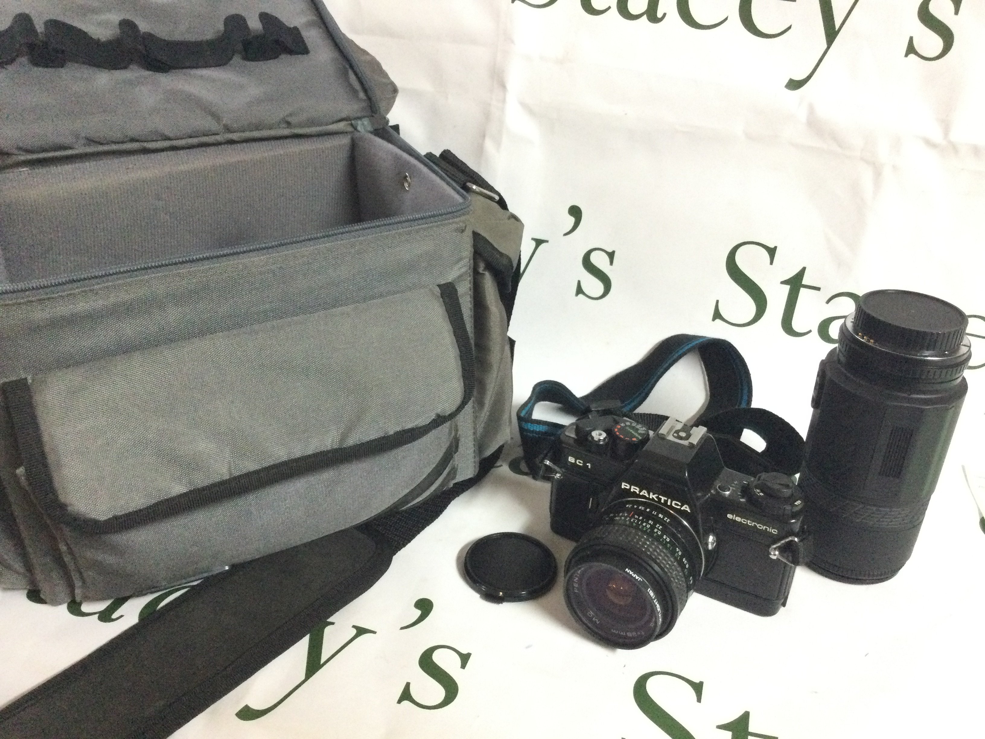 A Praktica BC1 camera and a Prakticar AF 55-200 mc lens , postage category b