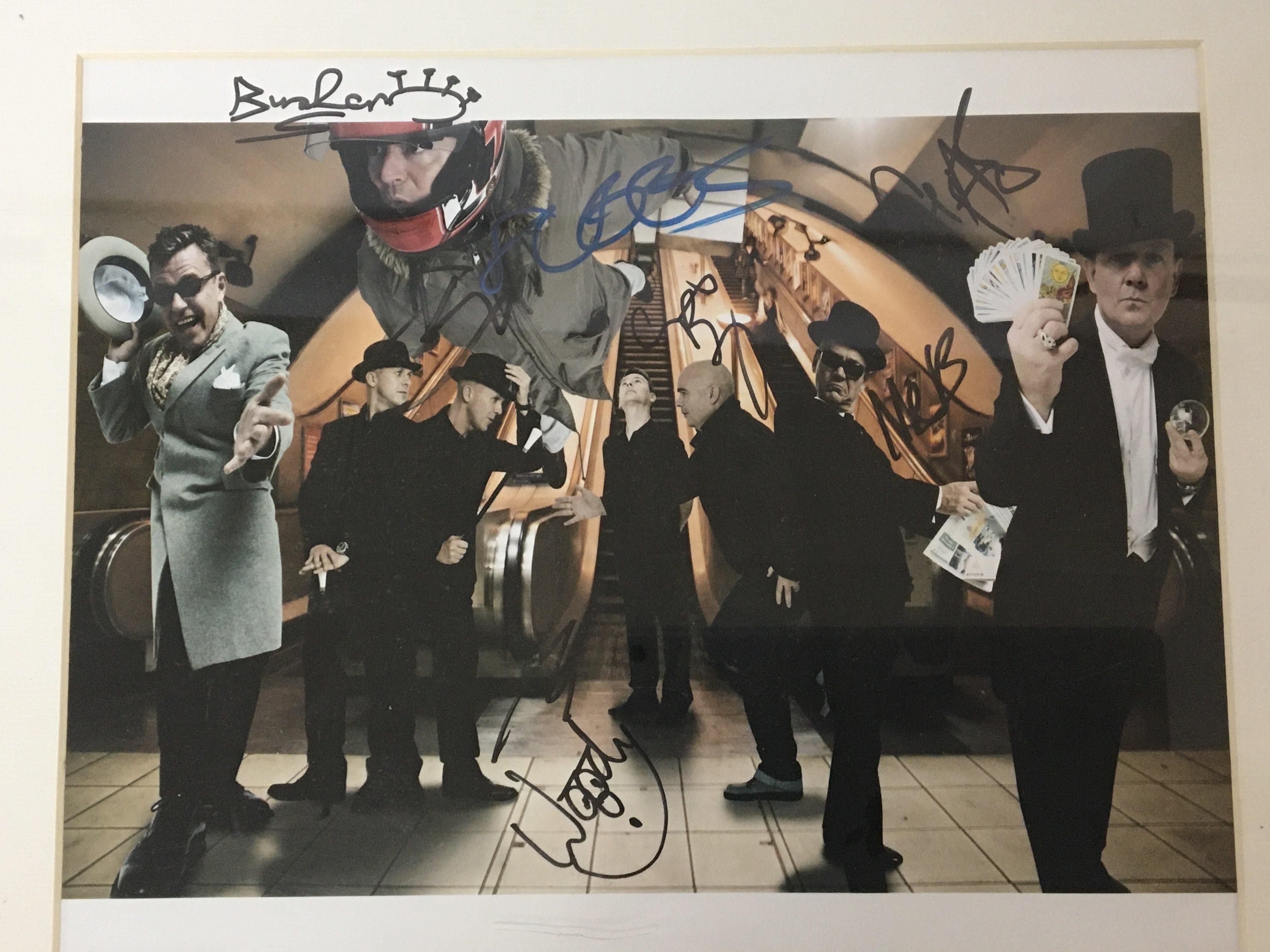 A signed Madness group photograph signed in Birmingham 2010 with certificate of Authenticity.