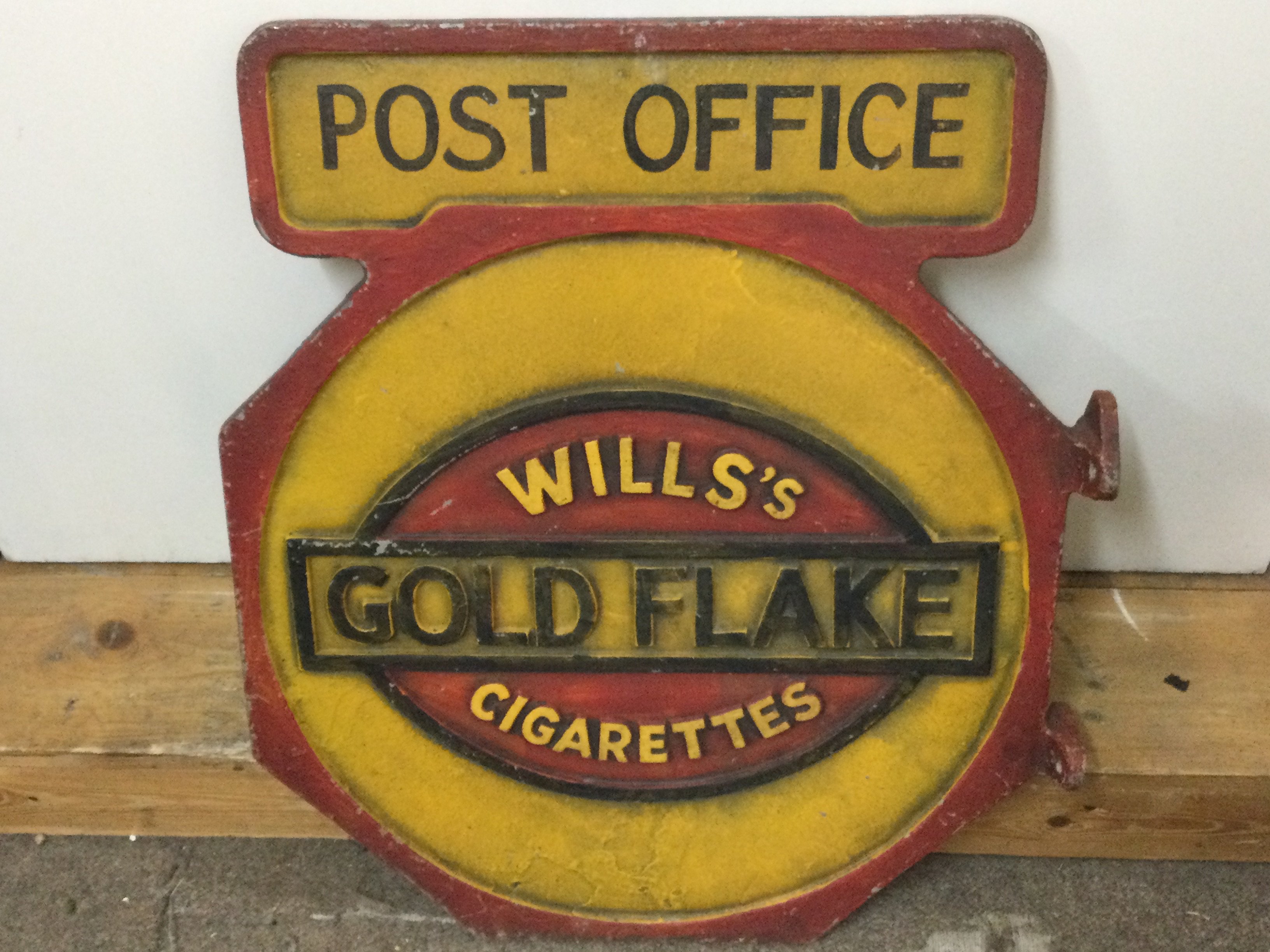 A cast iron retrospective Post Office Wills Gold Flake Cigarettes sign. 47m wide 55cm tall