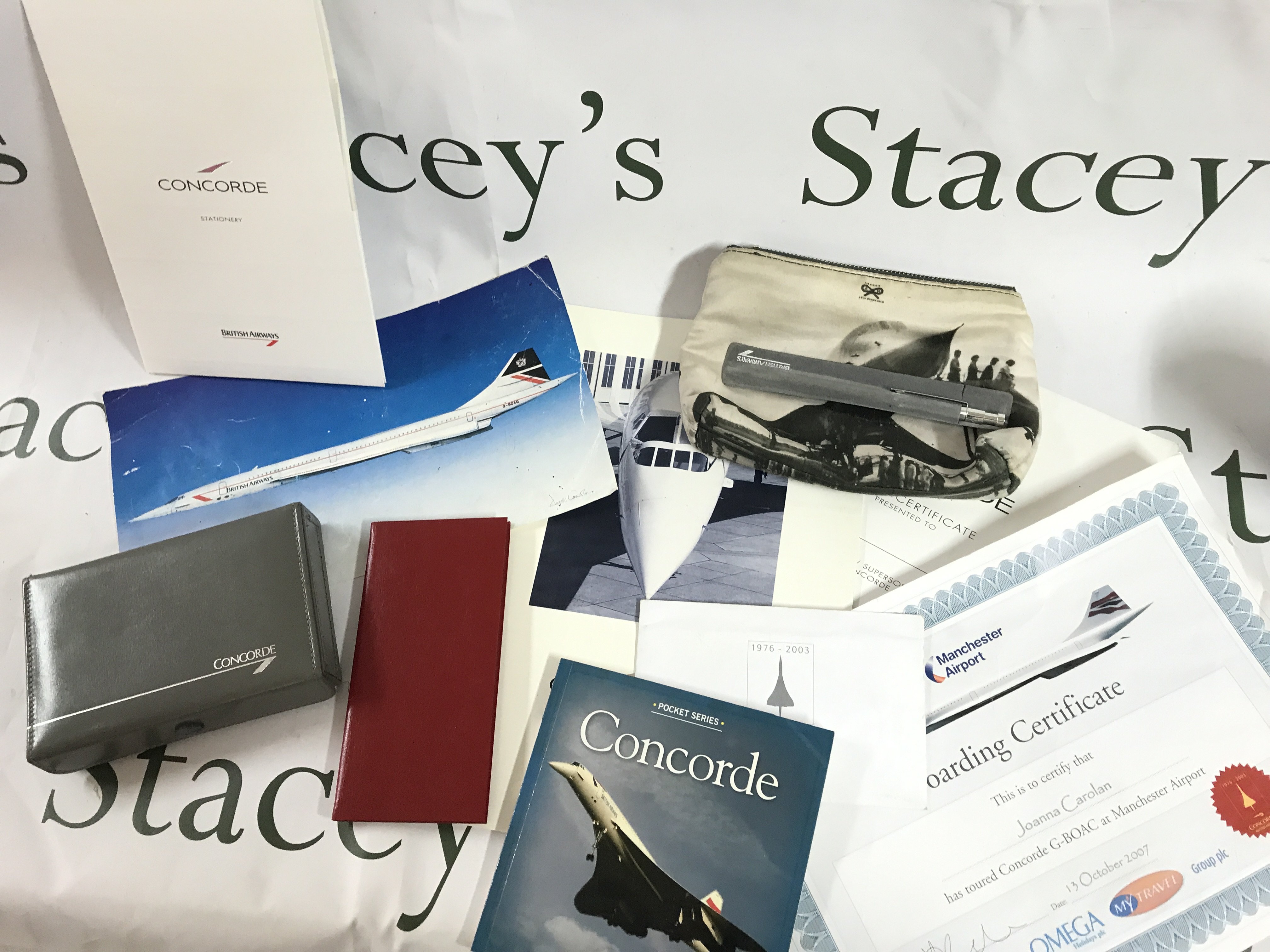 A box containing Concorde memorabilia including playing cards, note pad, pocket book, boarding certificate etc. postage category B