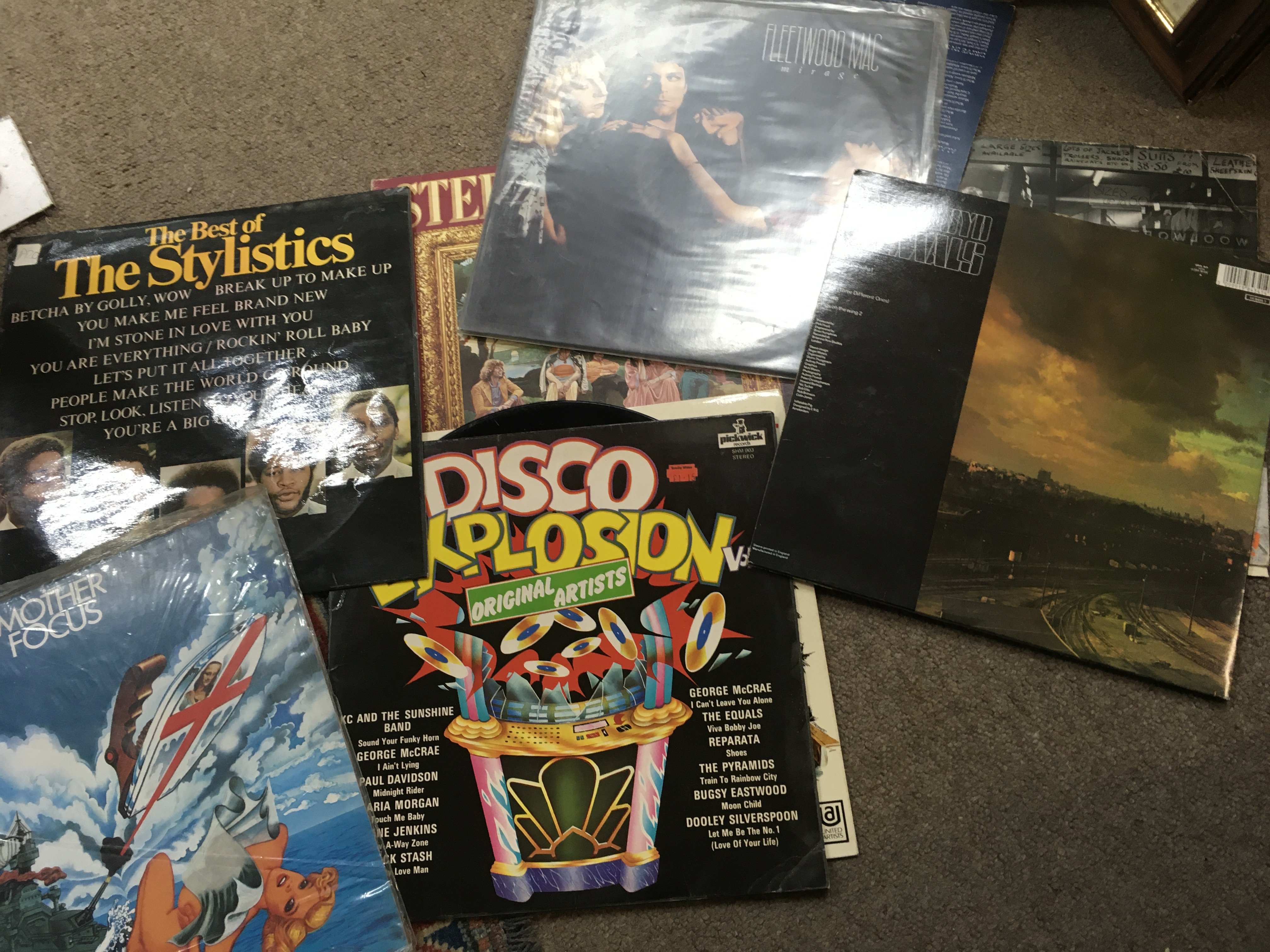 A box of various music albums including Fleetwood Mac and pink Floyd .