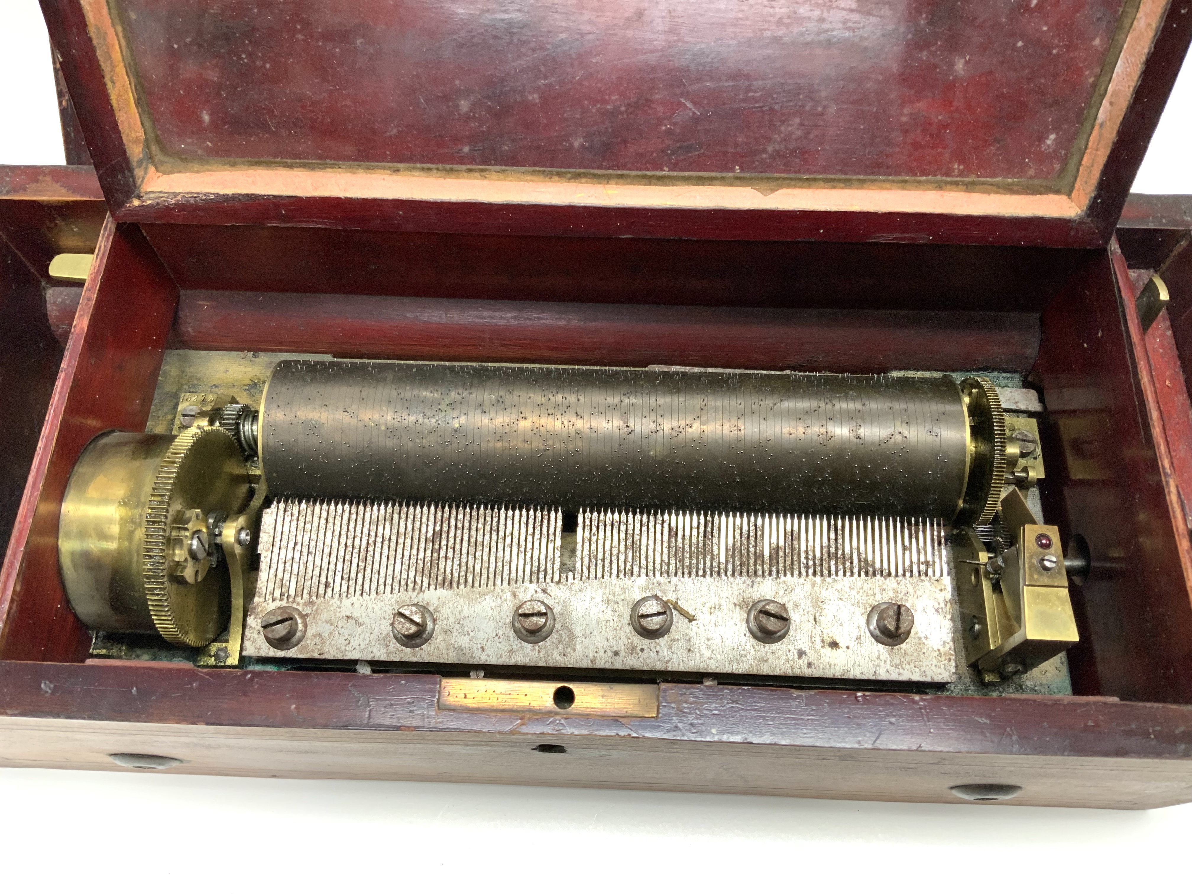 A small inlaid Victorian music box, in working condition, case in need of some restoration. 39cm x 13cm x 17cm. (D)