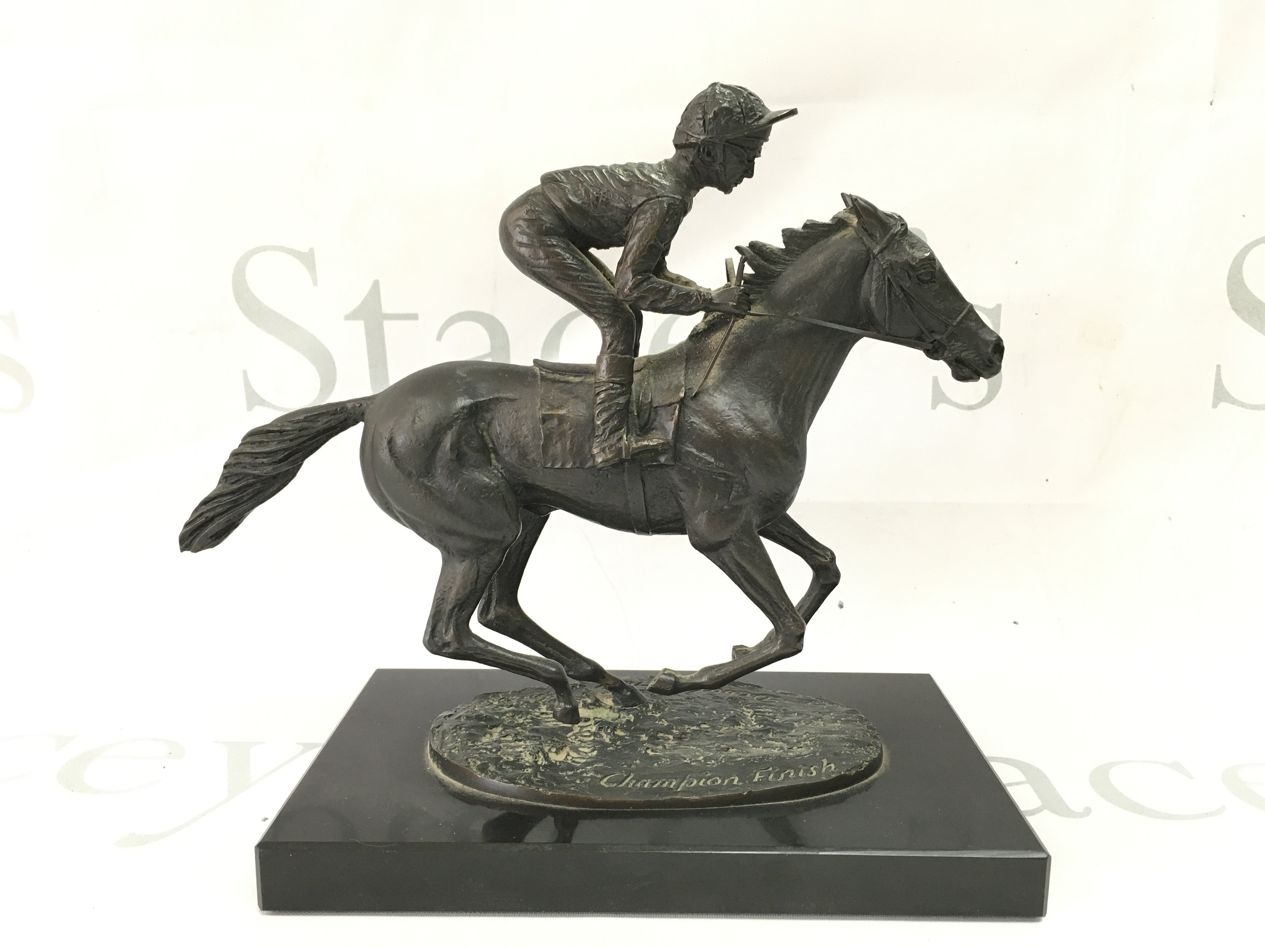 A modern bronze titled Champion Finish by David Cornell dated 1985. 20cm tall. Postage category B