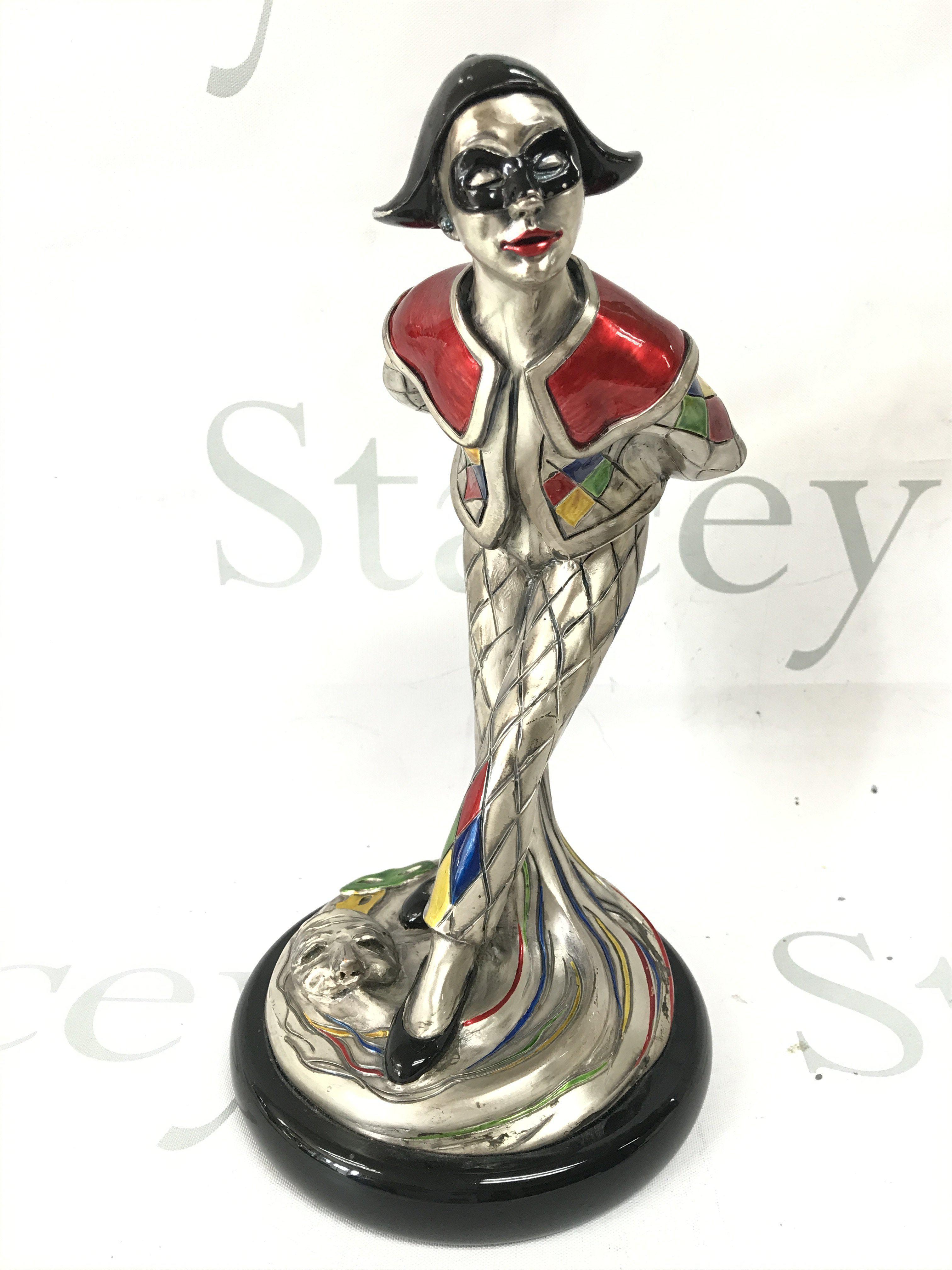 A sterling silver overlaid figure of a traditional Italian Arlecchino. Signed Midas. 25cm tall Postage category B