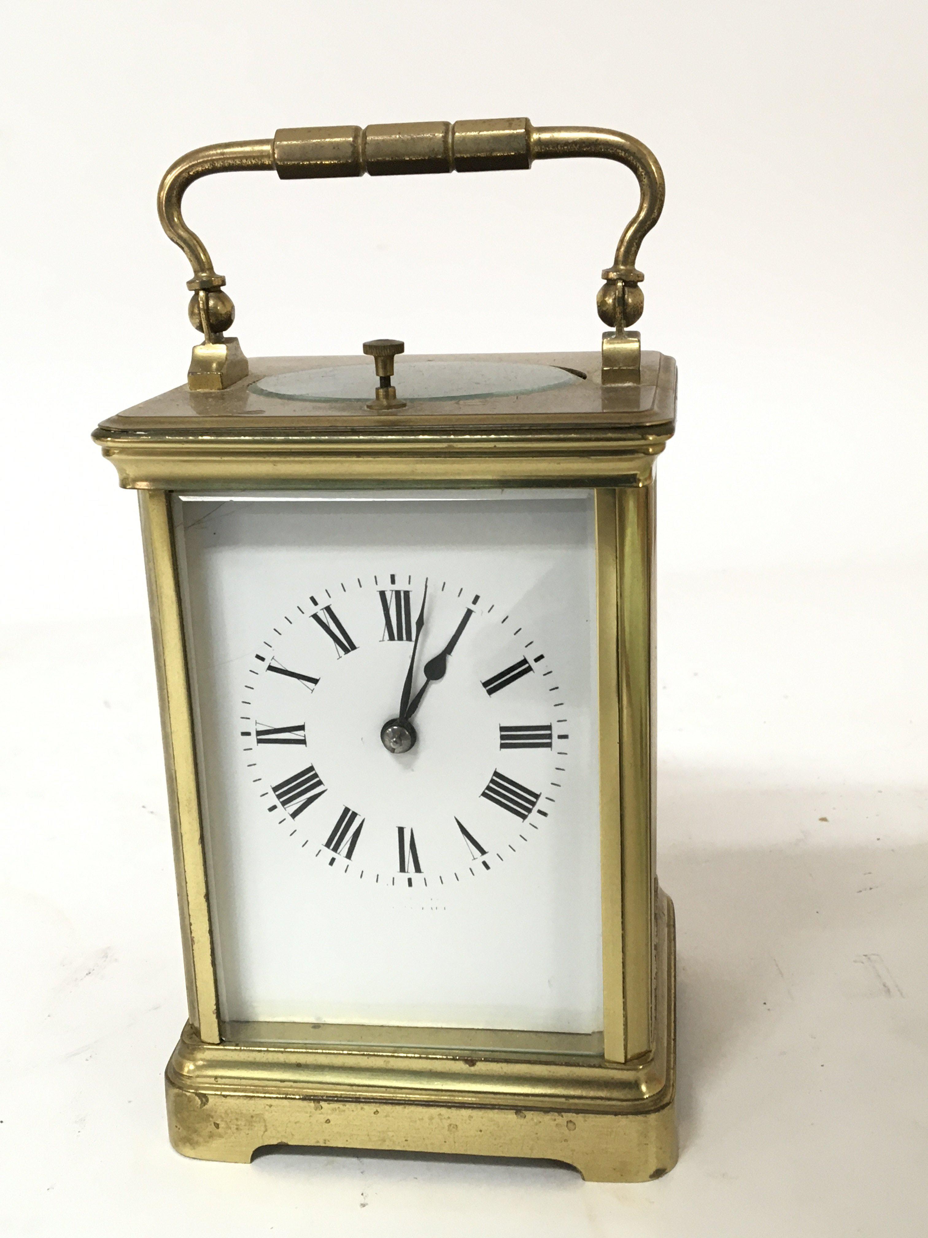 A French brass cased strike repeat carriage clock with a white enamel dial Hight 13cm