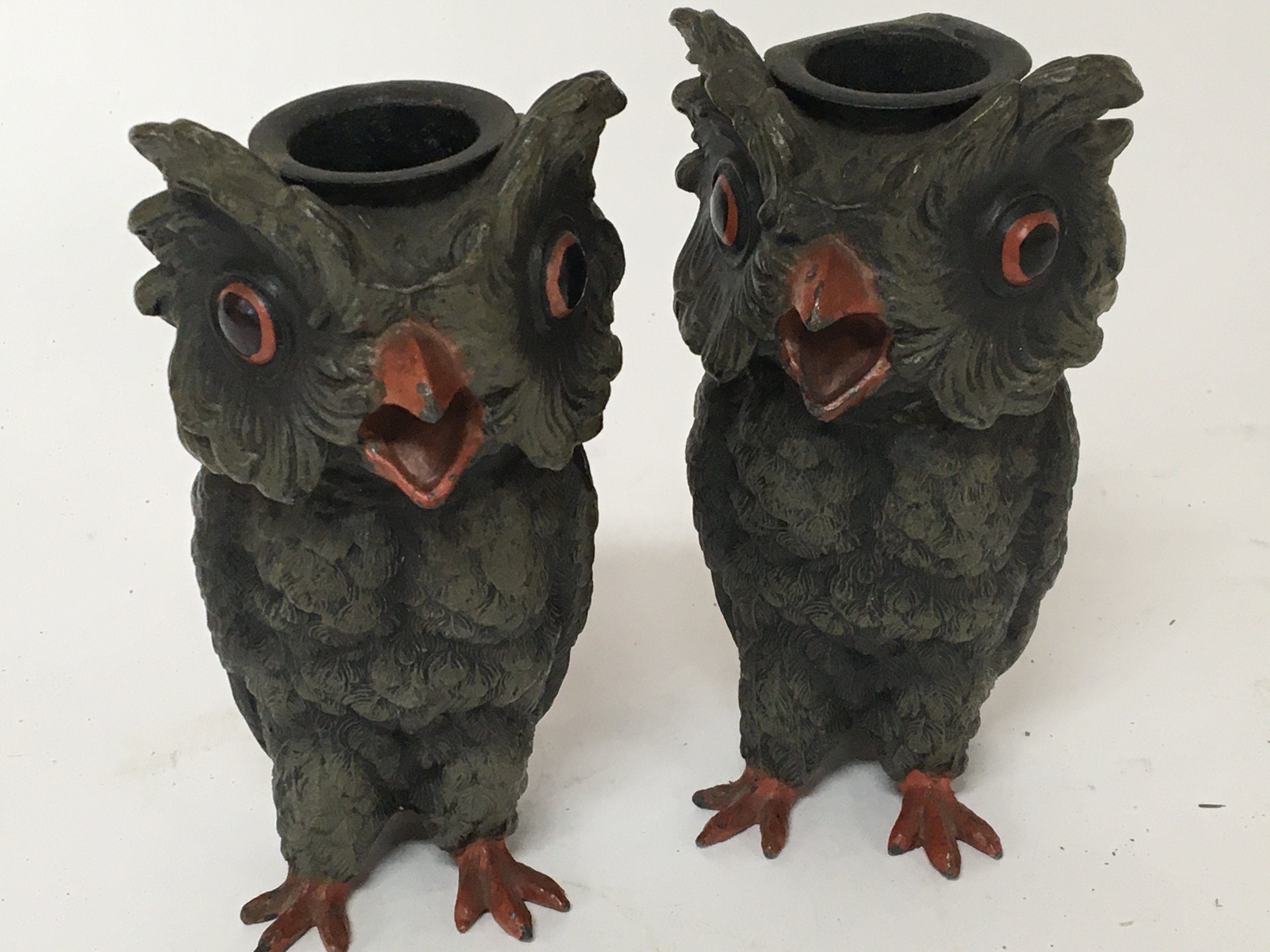 A pair of Novelty painted metal candle sticks in the form of owls. Hight 13cm.