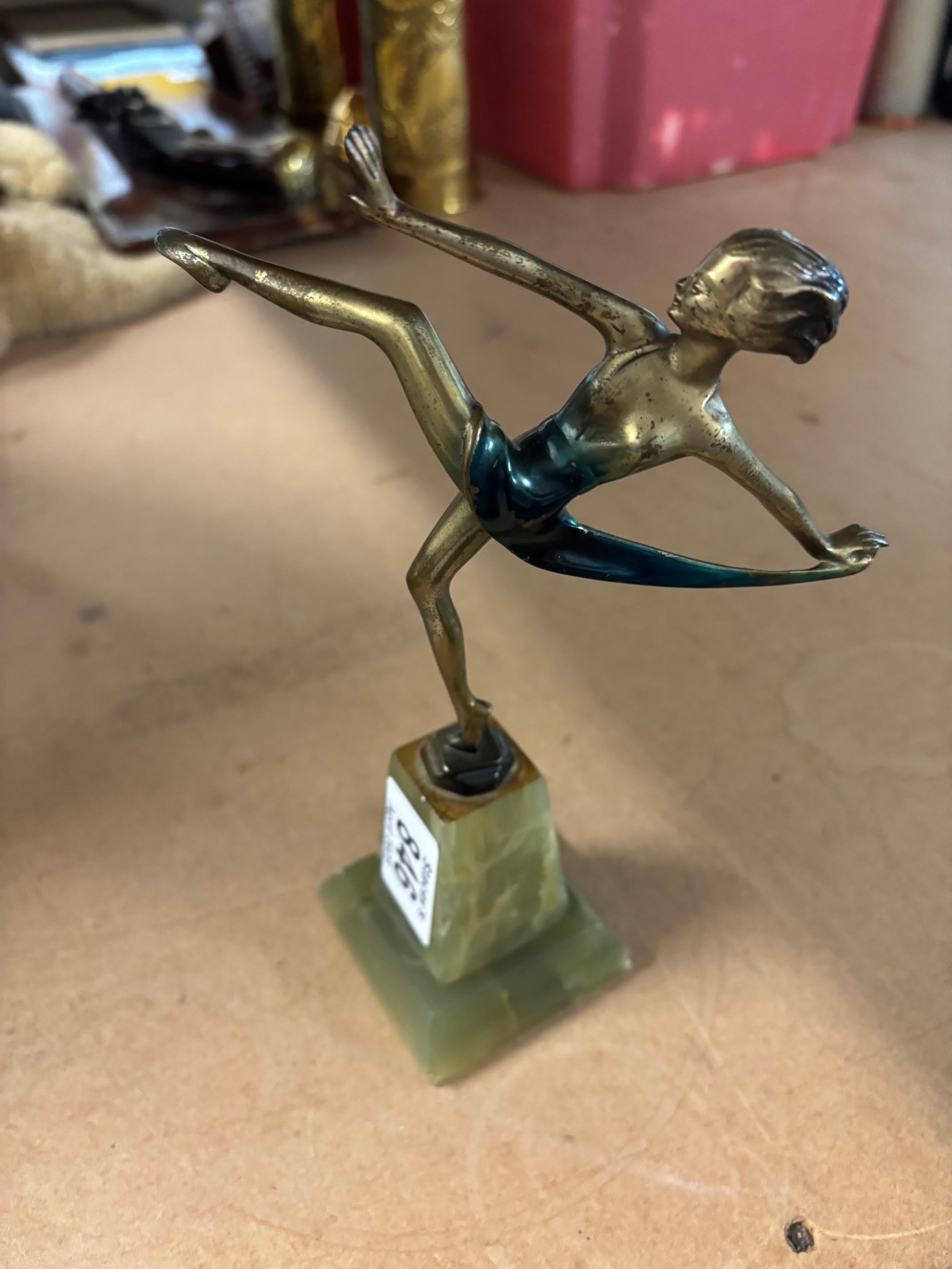 An 8" bronze on stone base figure attributed to Lorenzl. Chip to base and wear to dress.