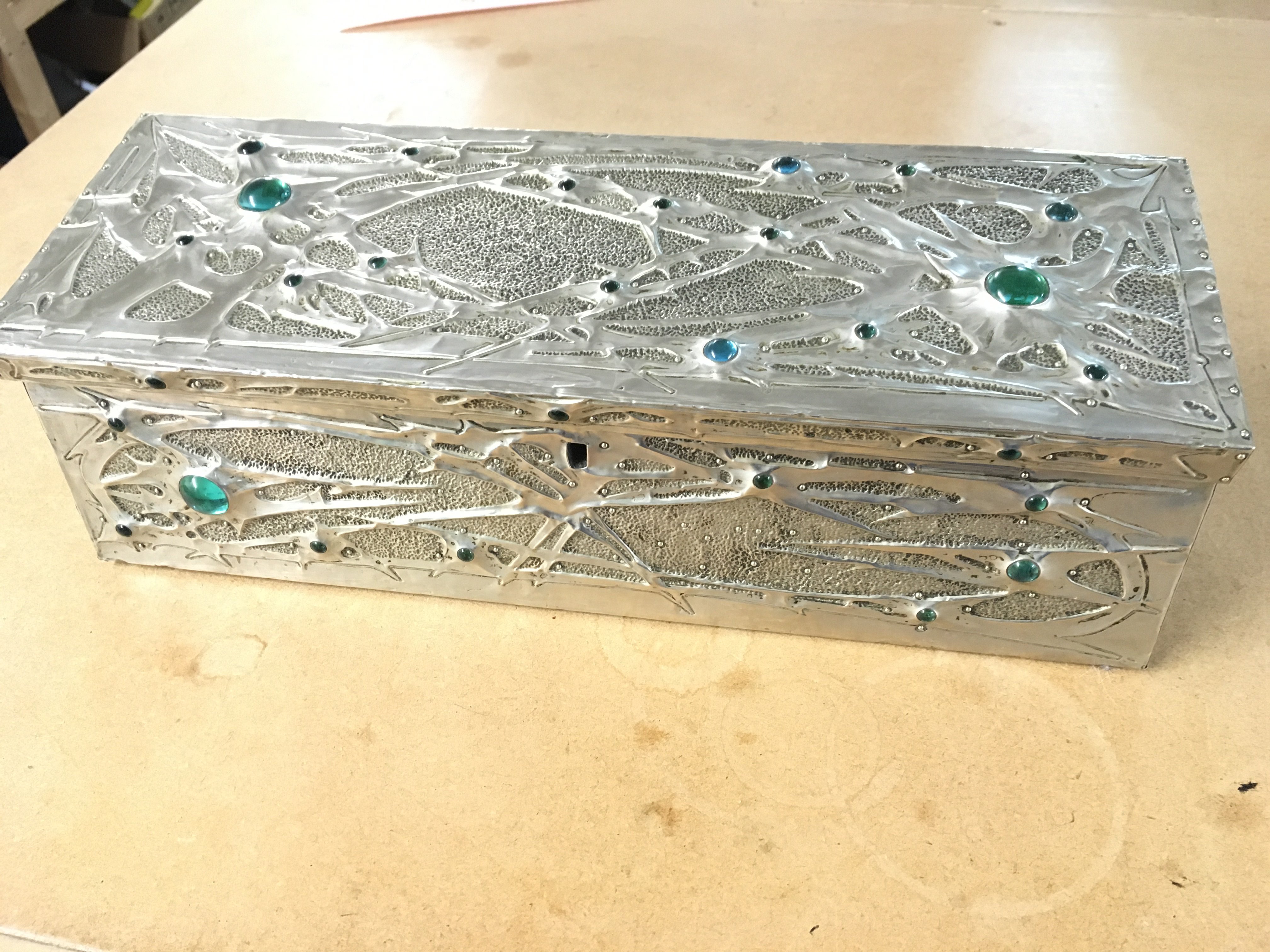 An art nouveau hand chased jewelled pewter box signed by unidentified artist france c1900 33cm wide 11 deep and 11cm tall.