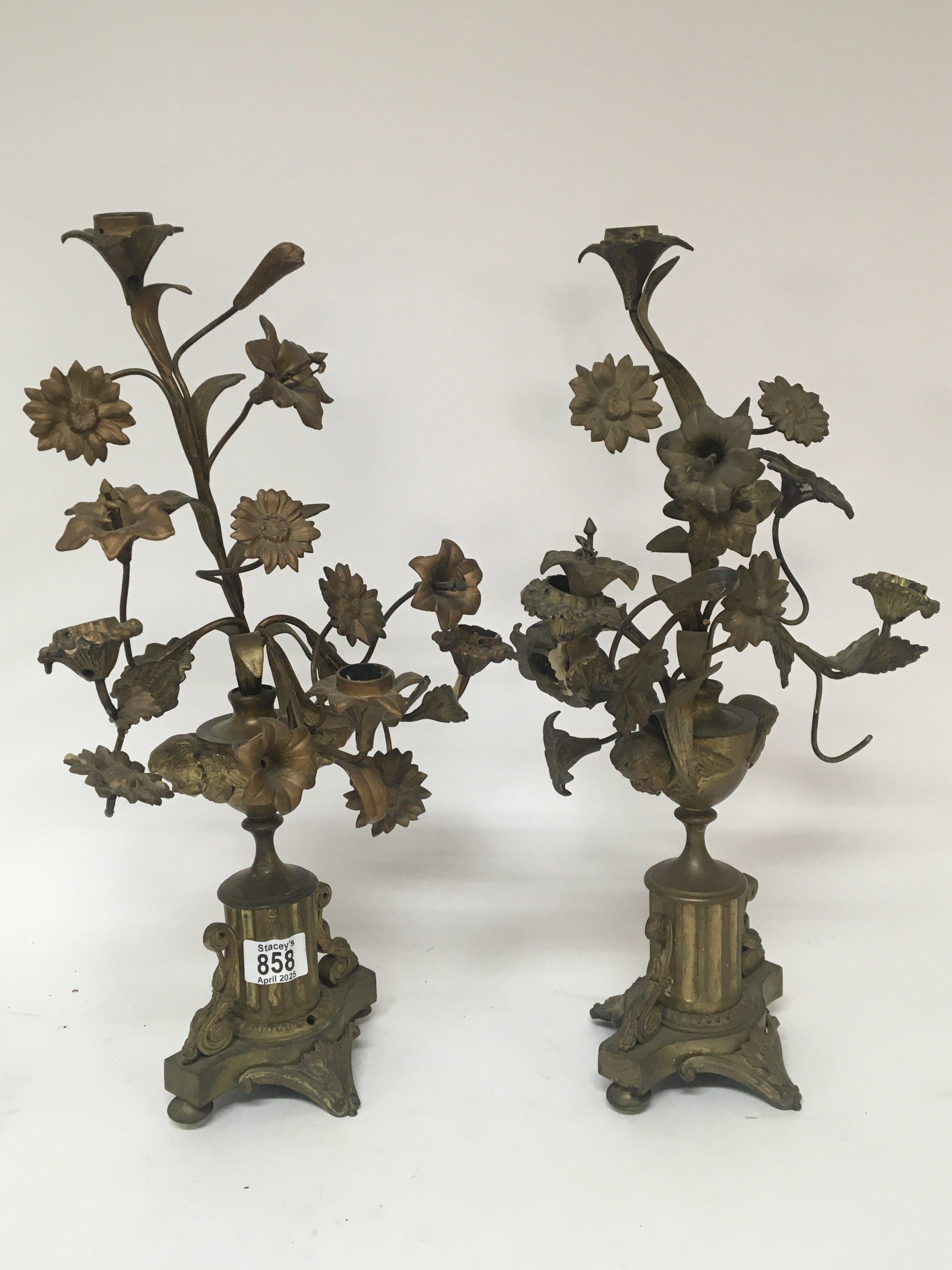 A pair of gilt metal table candelabra of French Rococo style. With raised flowers the sides with winged cherubs. Height 48cm