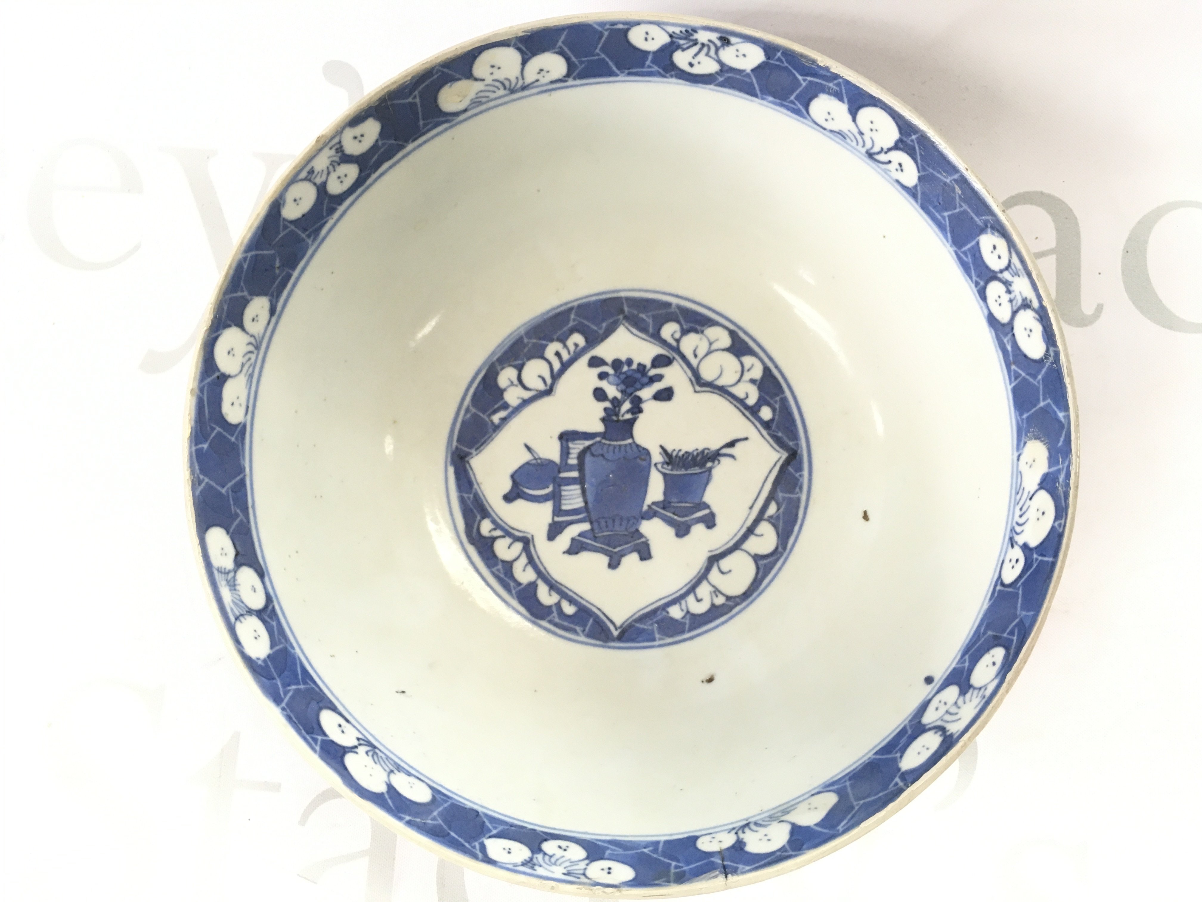 A 19th century Chinese blue and white bowl with a four character mark at the base, 18cm wide. Hairline crack seen and damage. This lot cannot be posted NO RESERVE