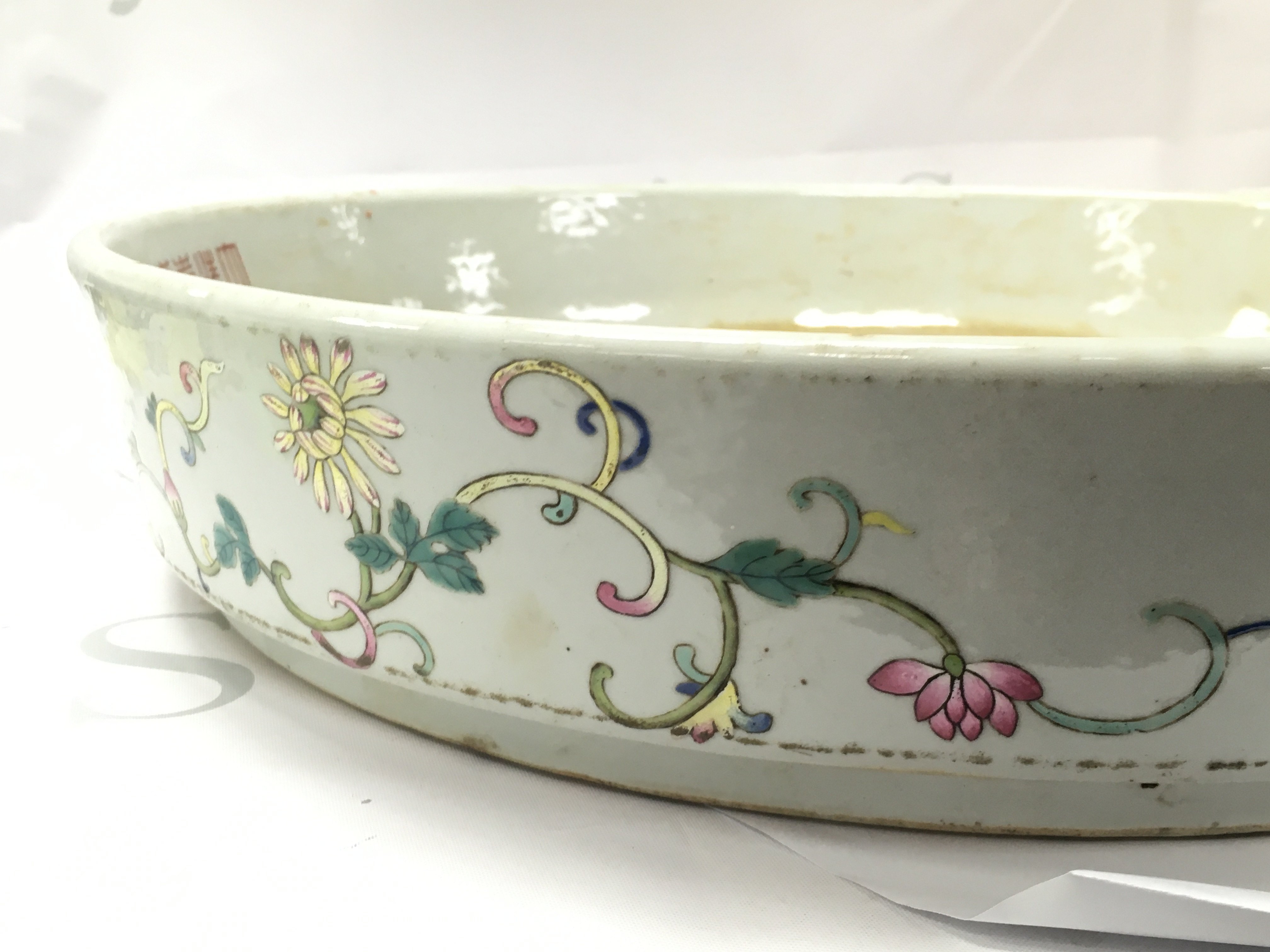 A Chinese Famille Rose Courtyard scene large dish , 41cm wide. No obvious large damage or restoration, some flaws in the glaze. This lot cannot be posted