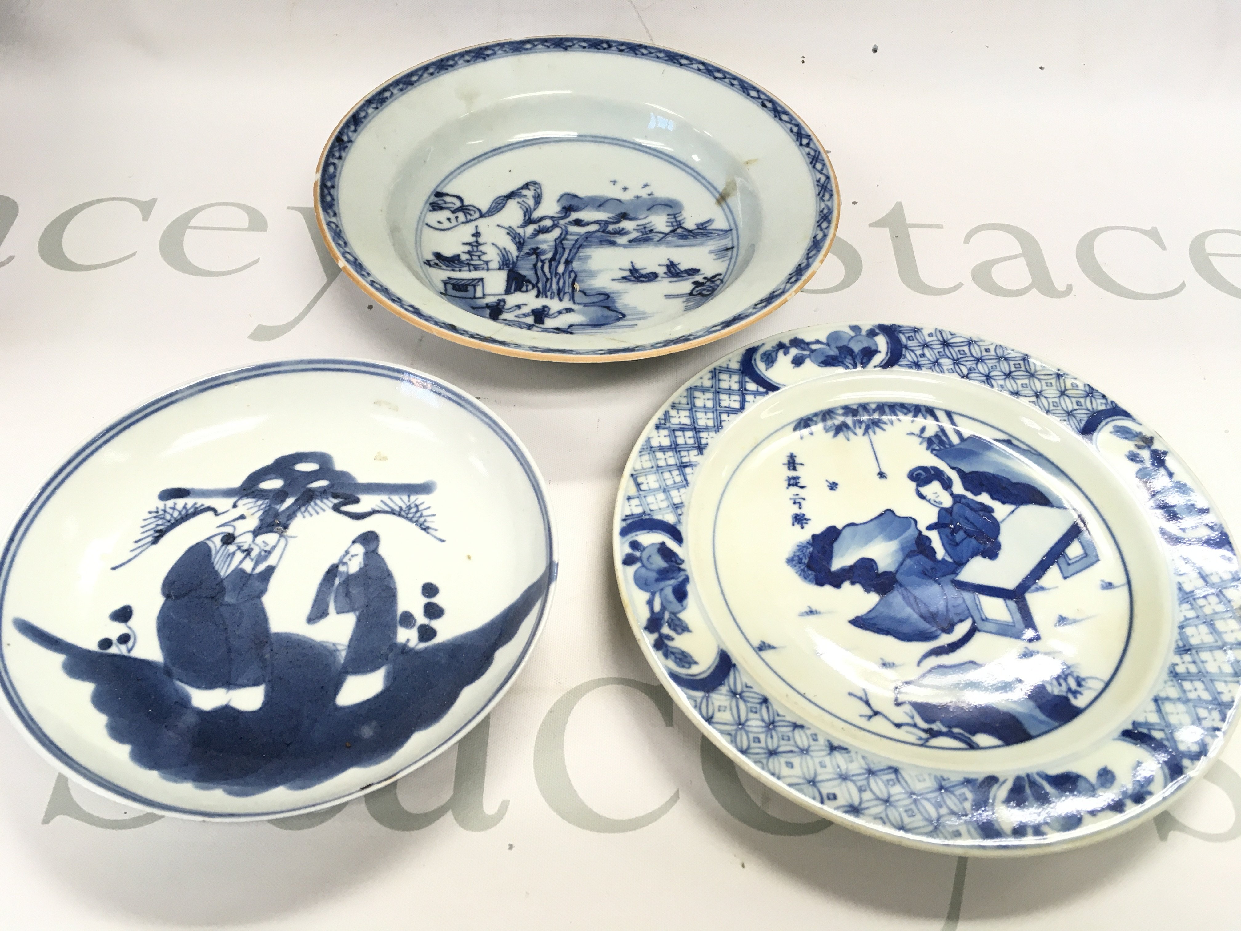 Blue and white dishes decorated with figures and river scenes , damage and restoration on one of the dishes. 13 to 16cm wide. This lot cannot be posted