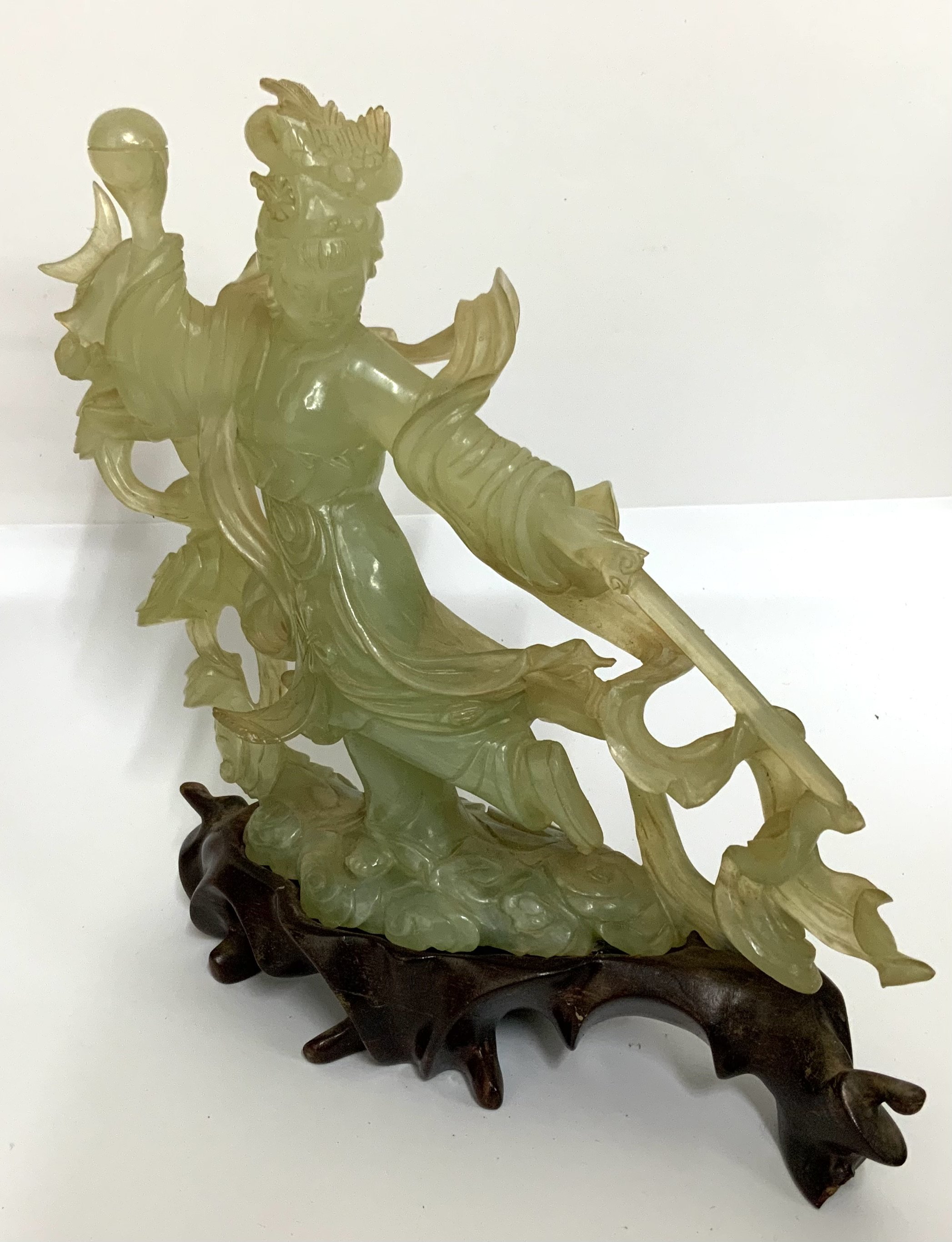 A 20thC carved Jade figure of a Chinese warrior princess holding a pearl and sword. (D)