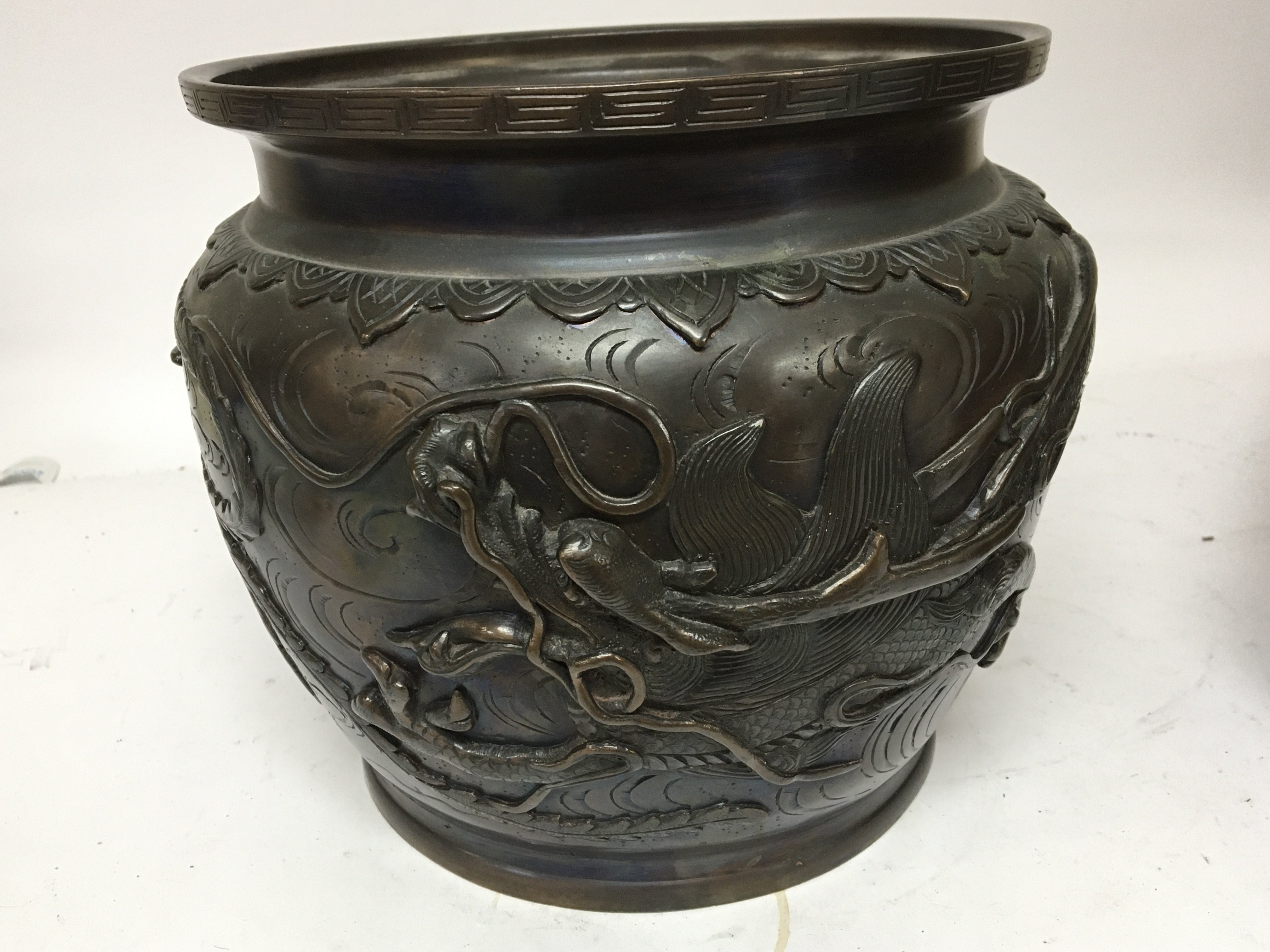 A Japanese late 19th century bronze jardiniere decorated with raised dragons signed base . diameter 26cm diameter.