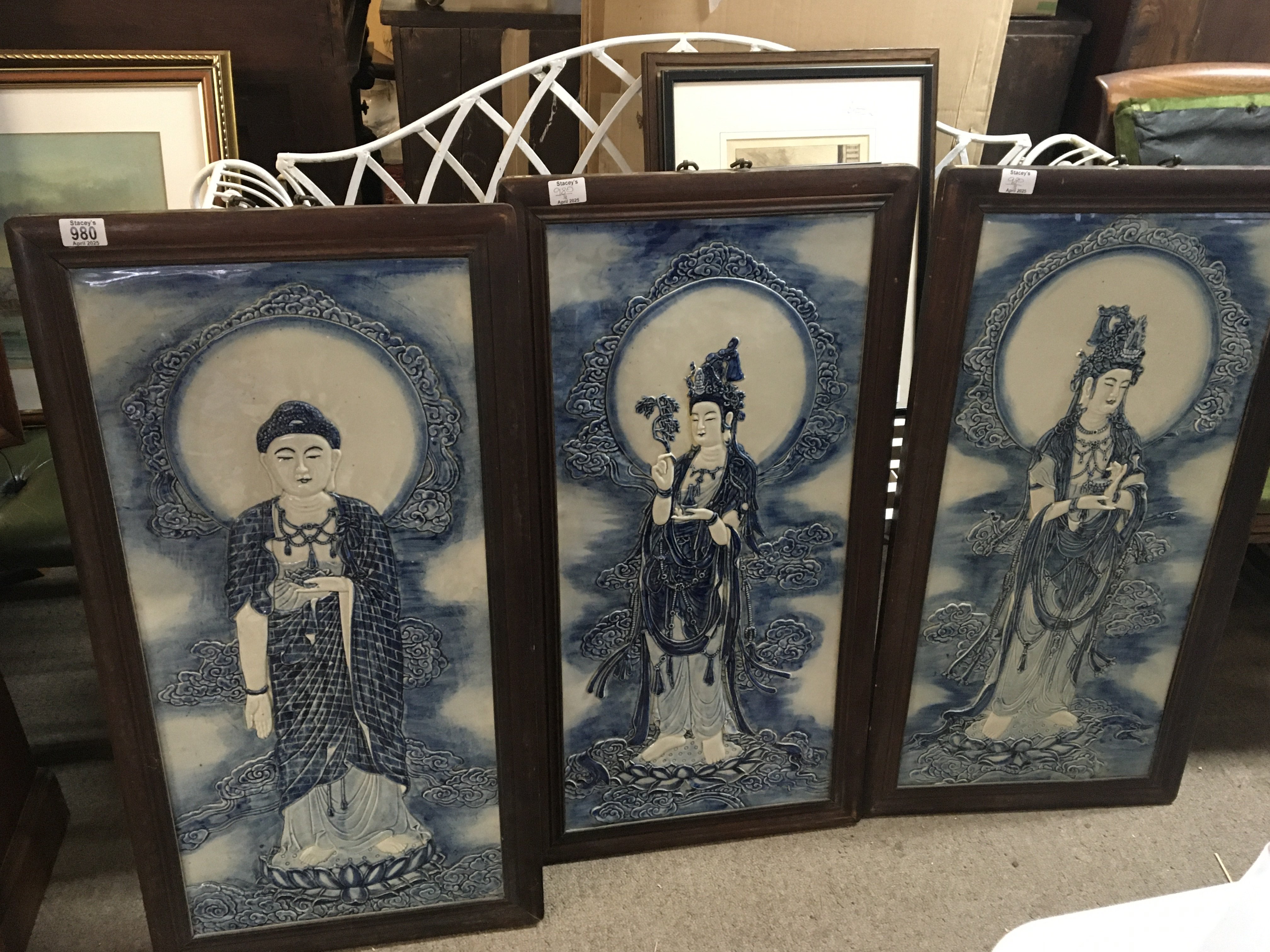 Three large early 20th century Oriental ceramic blue and white wall plaques each depicting a goddess in hardwood frames 89x46 cm (3)