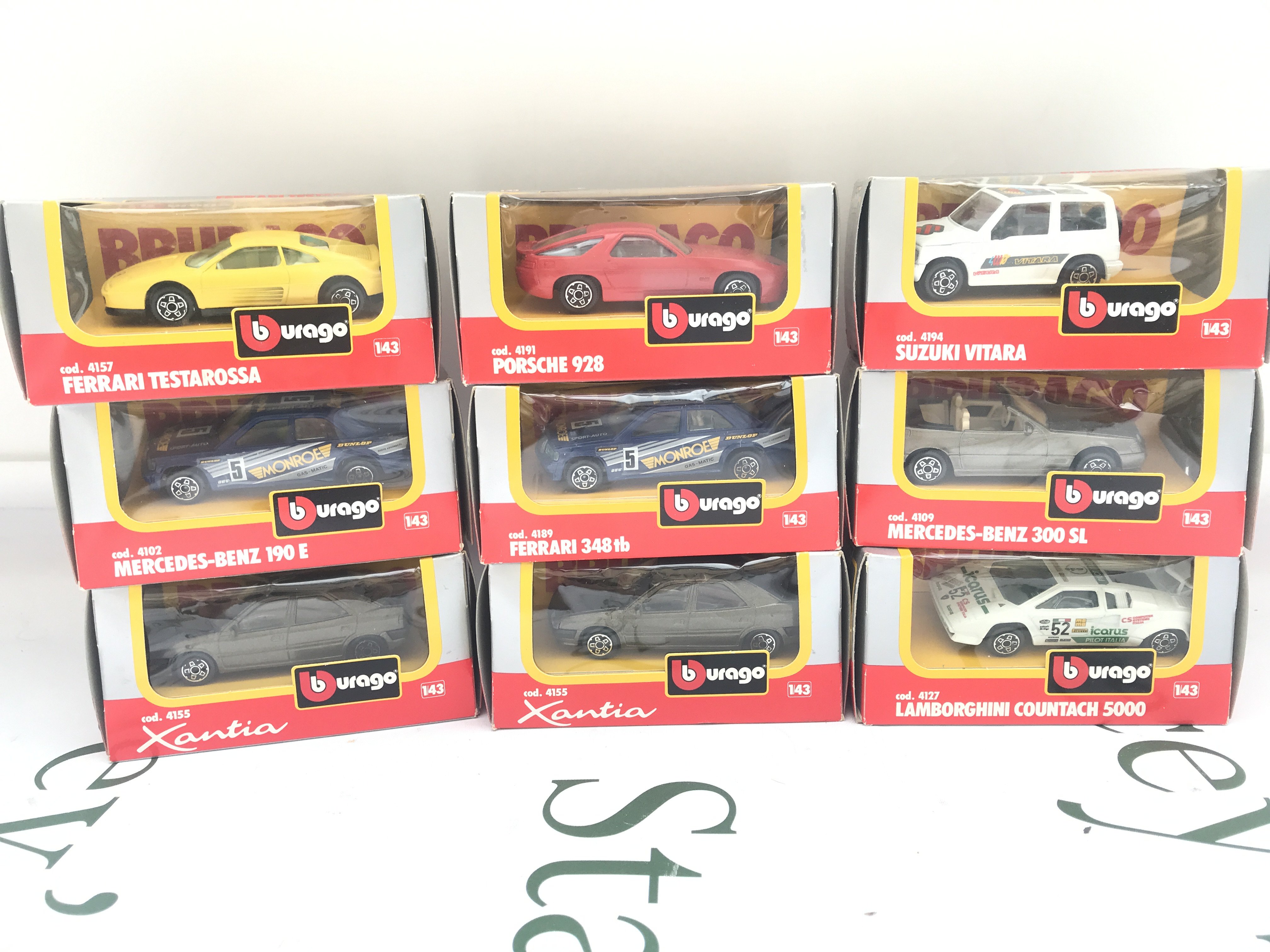 A Collection Of 9 Burago 1/43 Scale Diecast Cars.