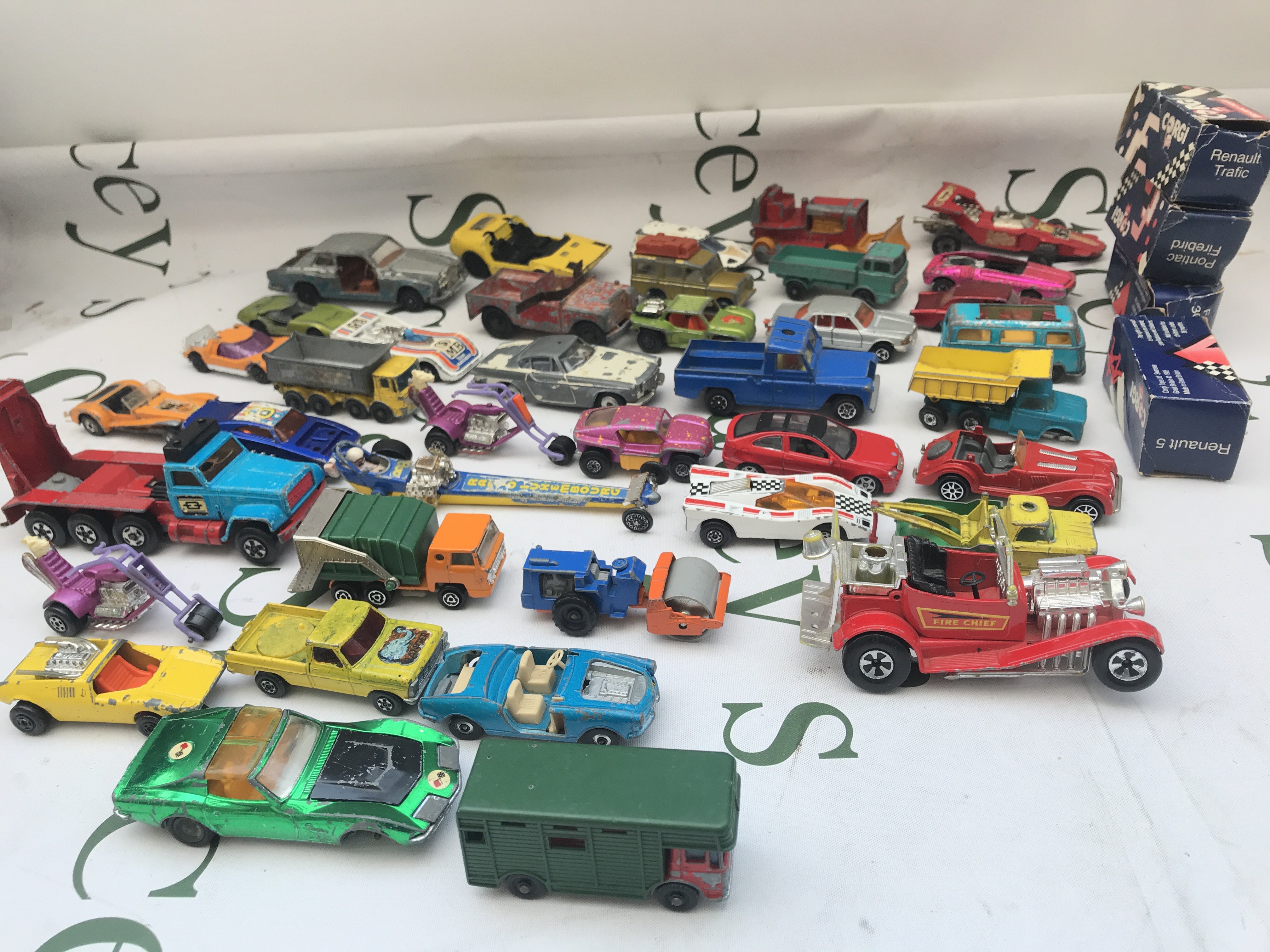 A Box Containing Playworn Diecast. Including A Batmobile With Batboat And Trailer.