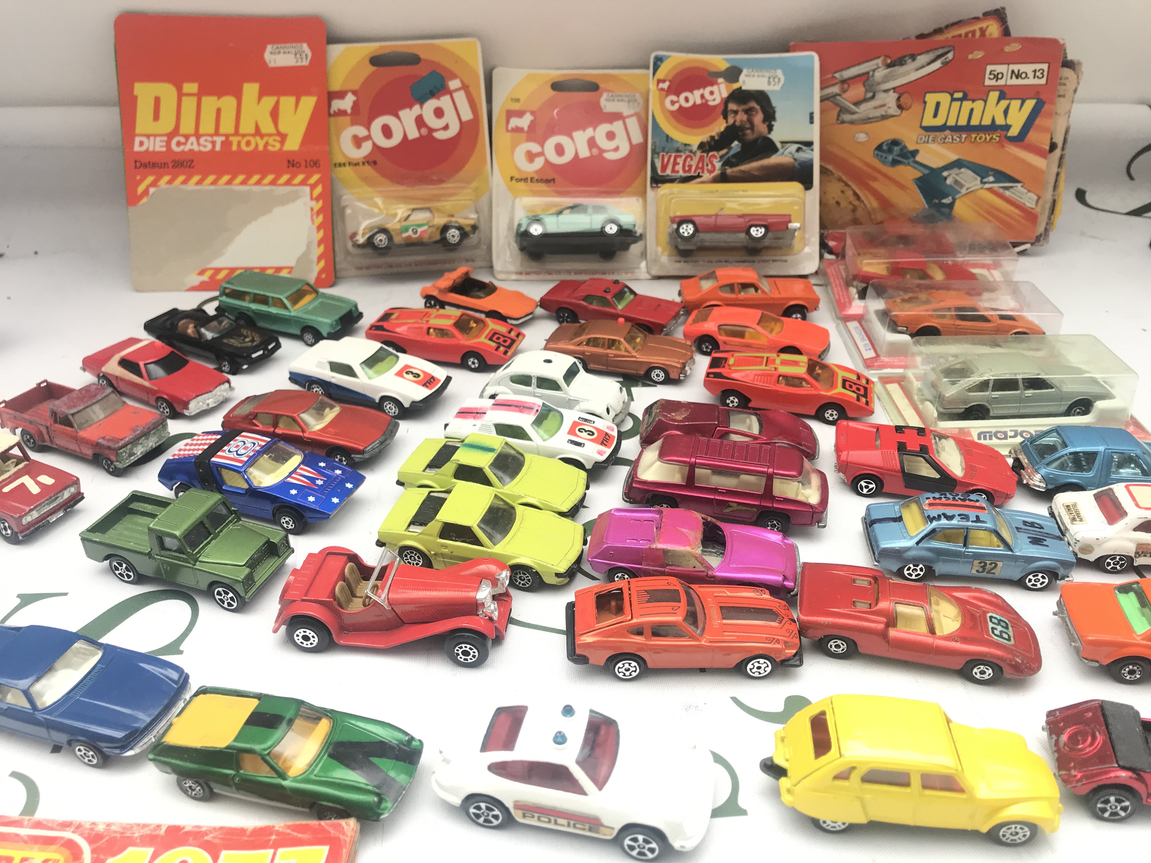 A Collection of Playworn and Carded Diecast Including Catalogs.