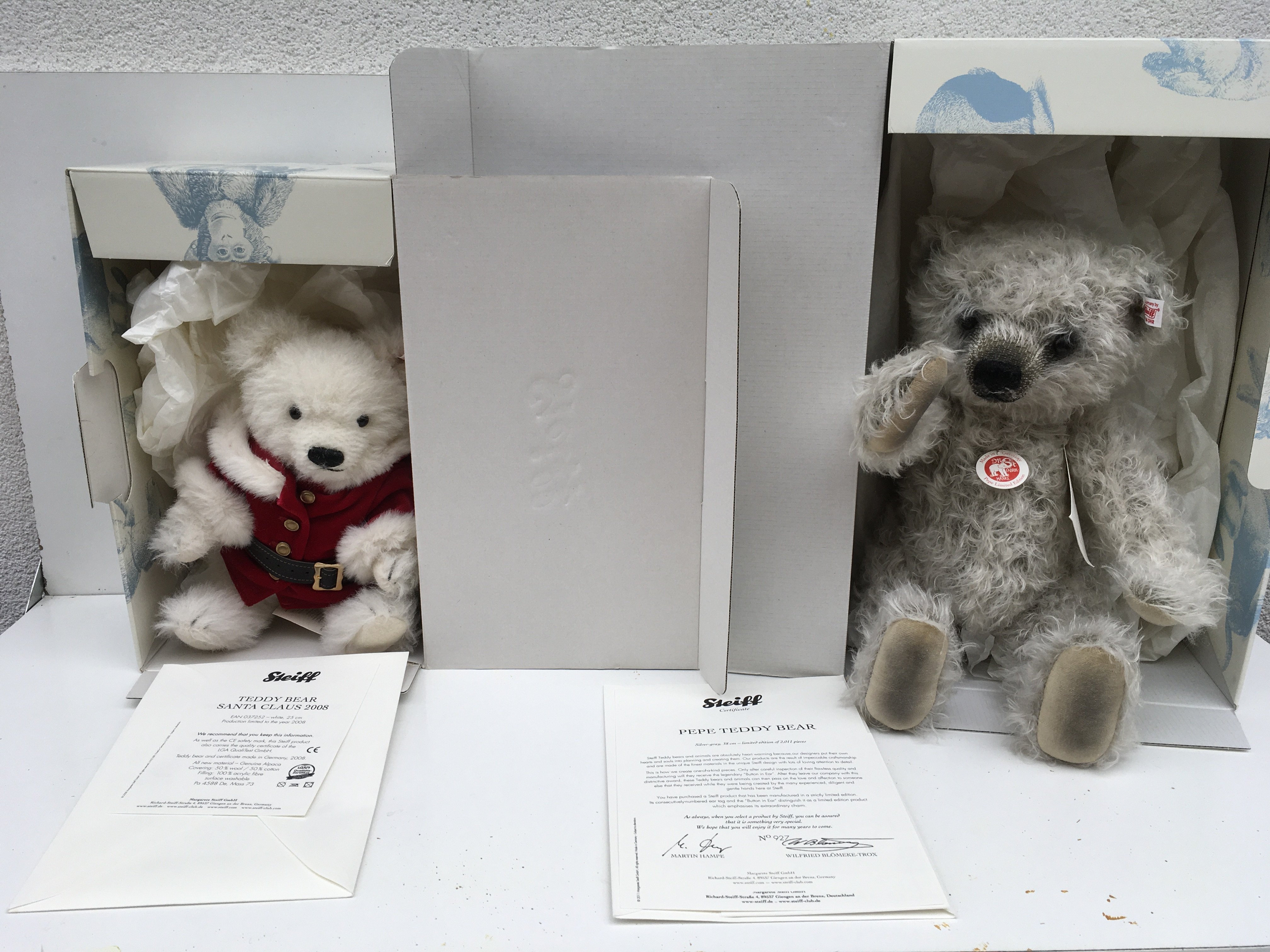 Two boxed Steiff teddy bears each with a COA featuring Santa Claus 2008 (25cms) and Pepe (38cms) 927 of 2011. Both have the Button in Ear. No reserve. (2)