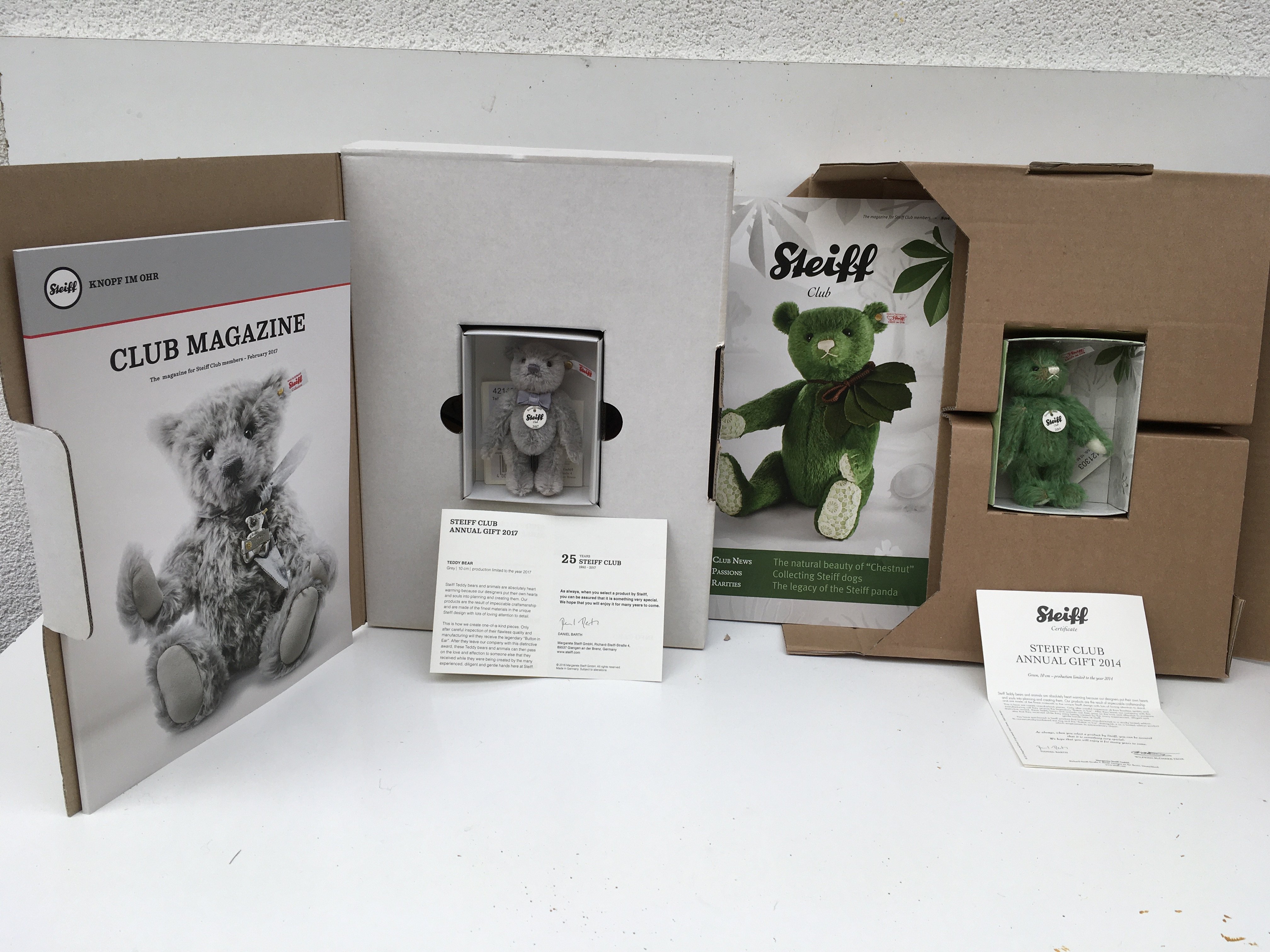 Two boxed Steiff minature teddy bears produced as Steiff club annual gifts. Features a green bear (10cms) 2014 and a grey bear (10cms) 2017. Both with certificates. No reserve (2)