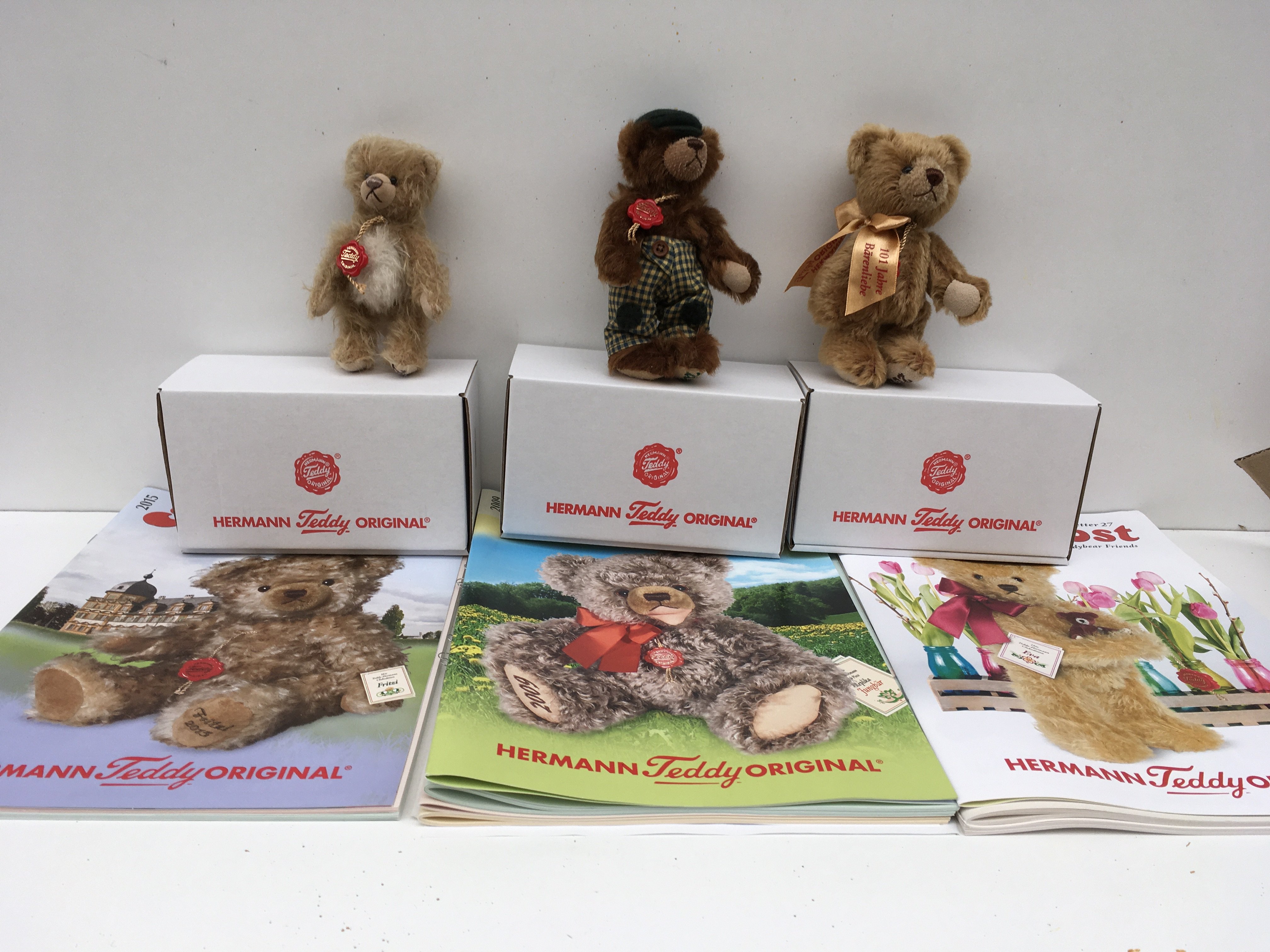 Three boxed Herman minature Teddy bears featuring 2009 dark brown bear a 2013 golden brown bear and a 2015 light brown white tippled bear, includes associated magazine. No reserve.