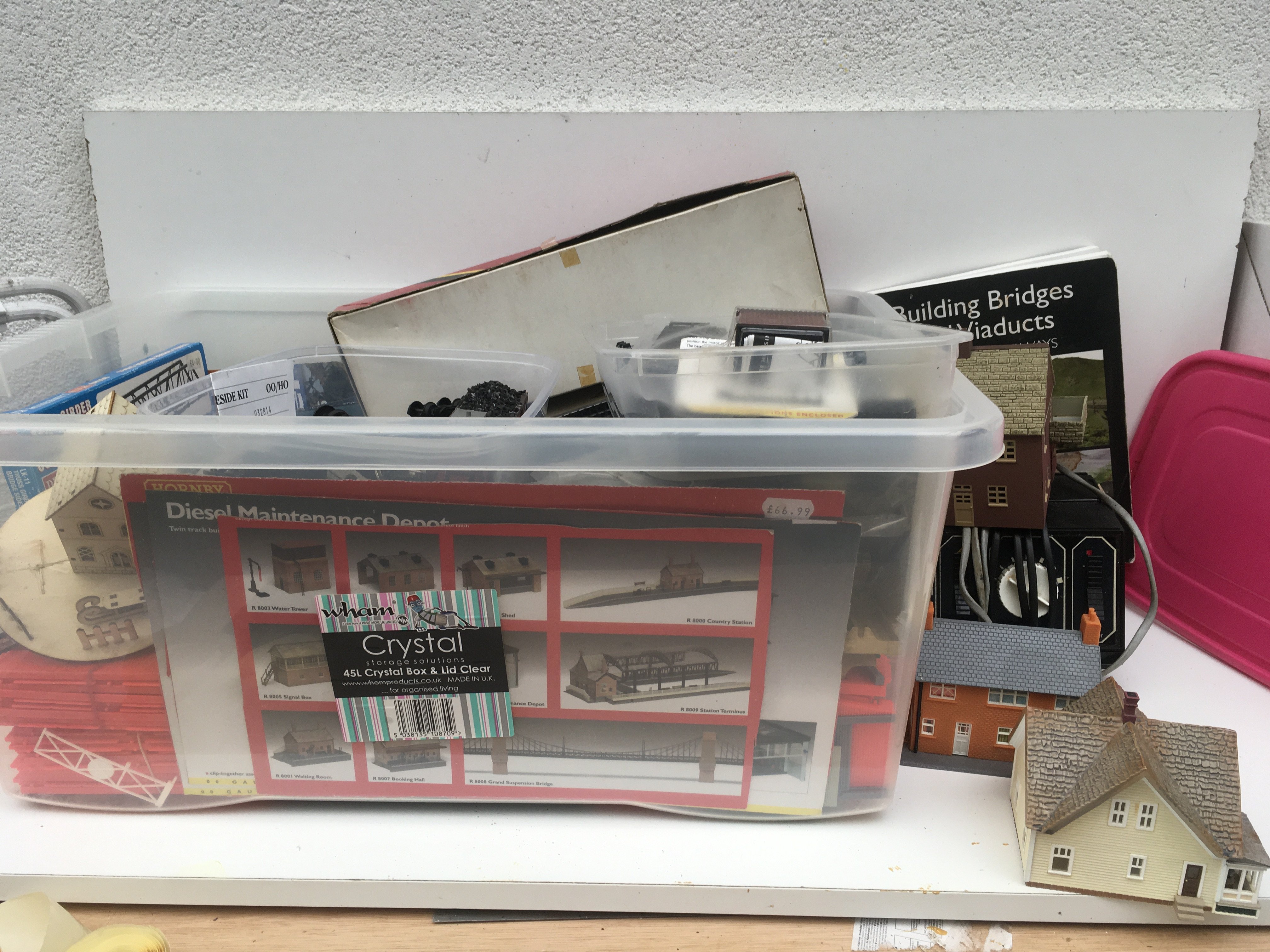 A large box containing an assortment of 00 and HO gauge model railway accessories including buildings..track..power supply etc. manufacturers include Hornby..Peco and others. No reserve