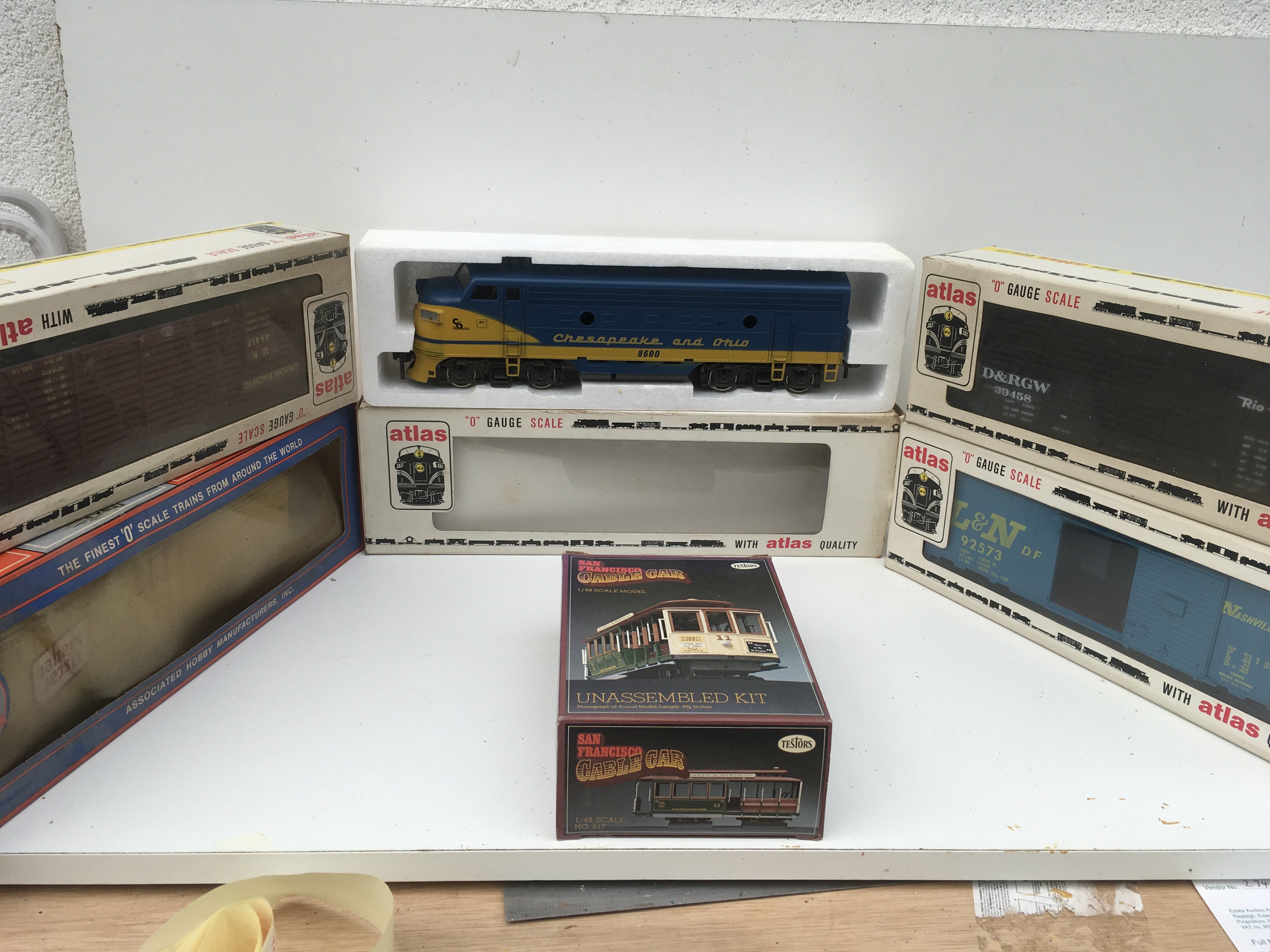 A Boxed O gauge model locomotive by Atlas Chesapeake and Ohio plus 4 boxed O gauge wagons and a boxed model kit for SanFrancisco cable car. No reserve.