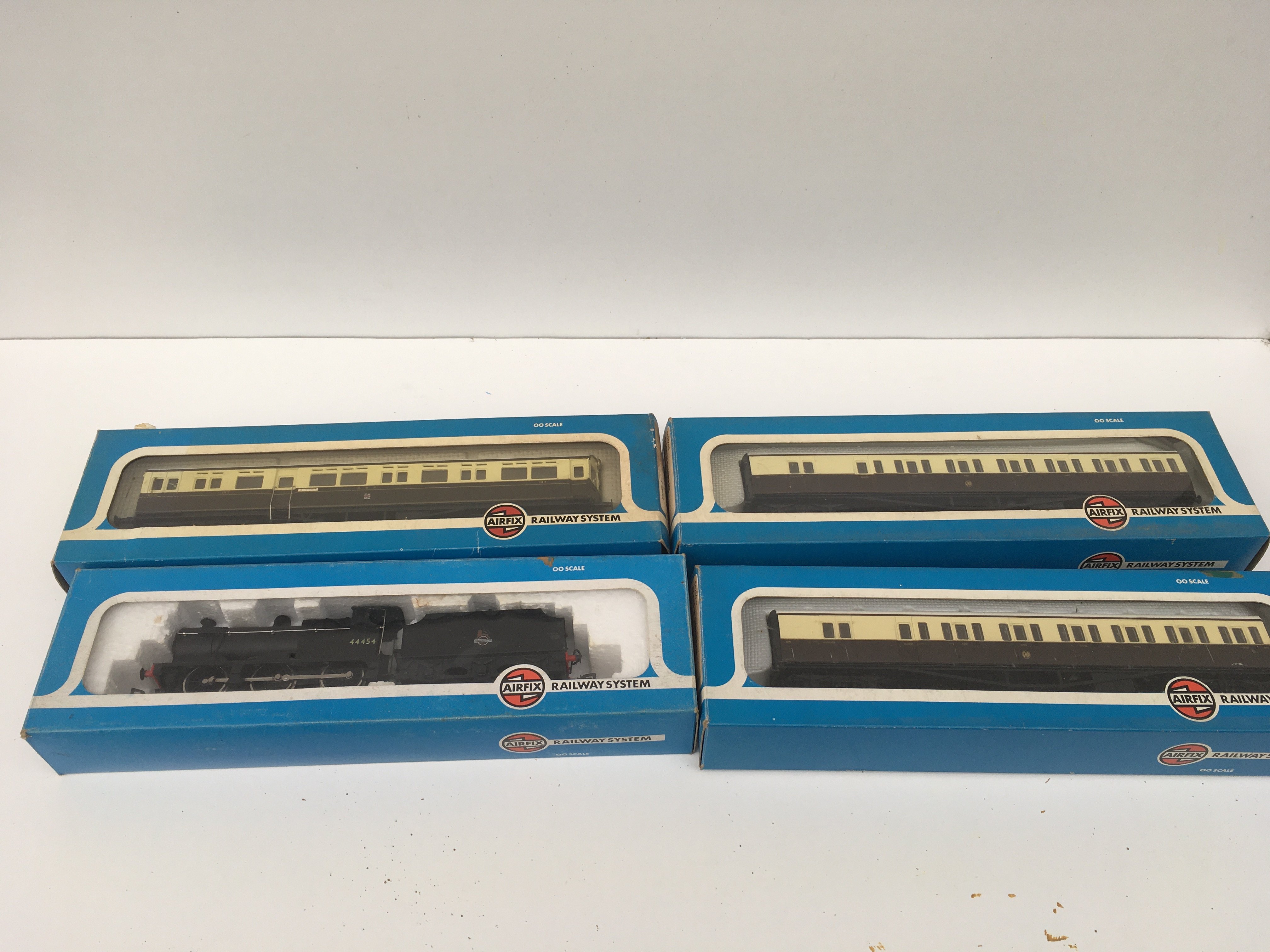A collection of 4 boxed 00 gauge pieces by Airfix comprising a 4F Fowler locomotive and 3x coaches. No reserve.