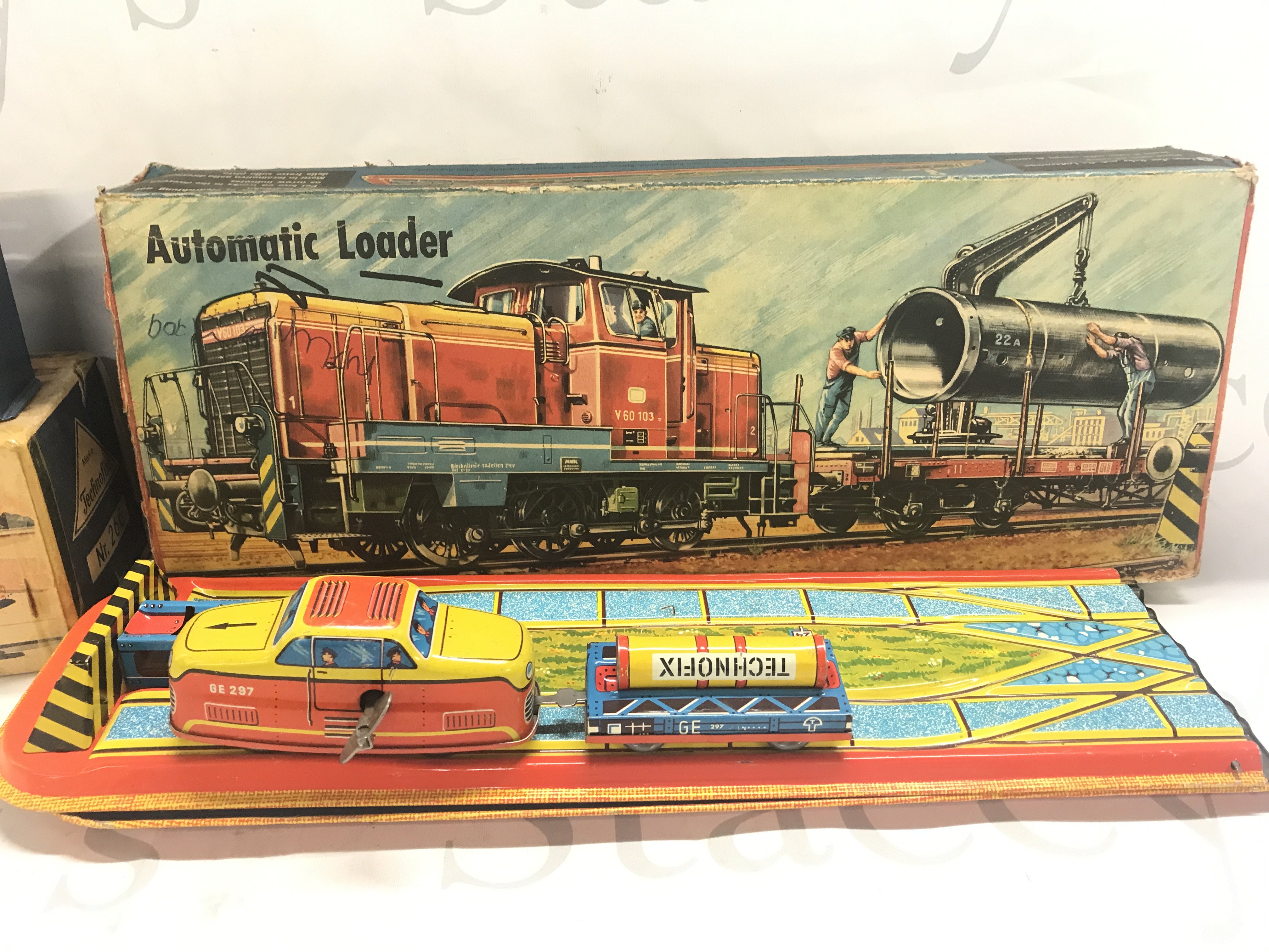 A Boxed German Tinplate Car Elevator And A Automatic Loader.Boxes Are Worn.