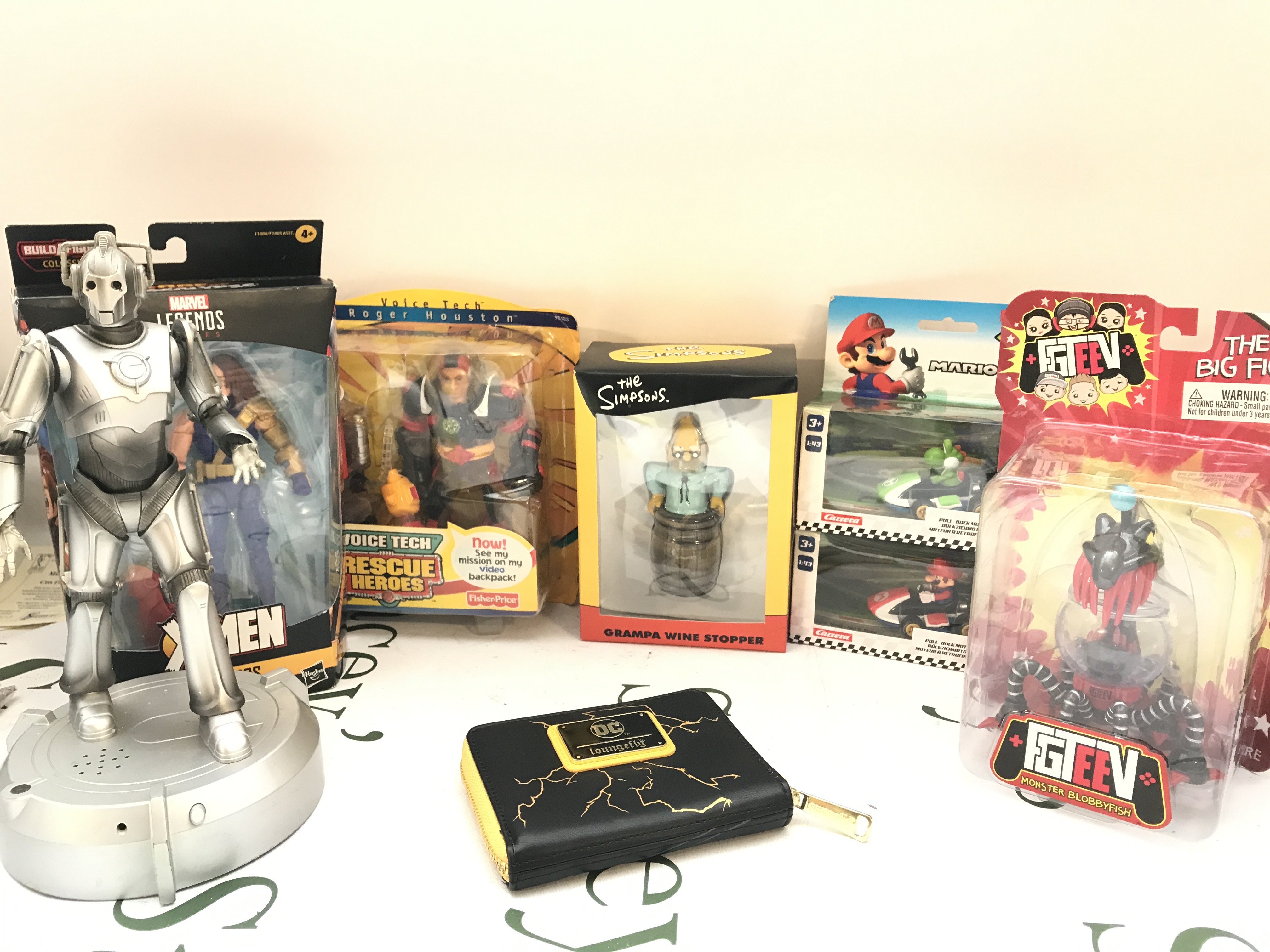 A Collection Of Various Boxed And Loose Toys Including The Simpsons. Mario Kart. Etc. No Reserve.