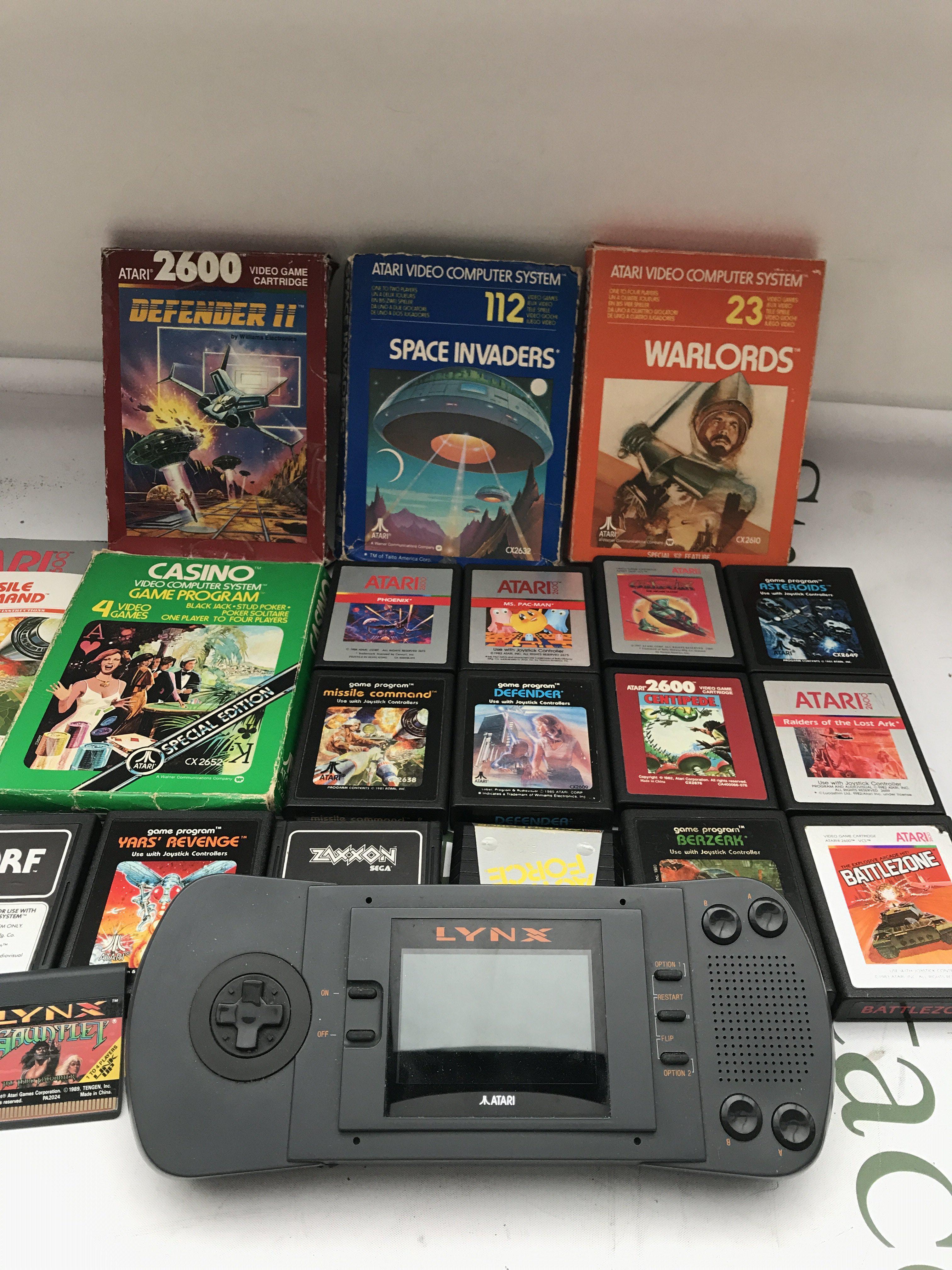 A Collection of Atari Games And An Atari Lynx With One Game. Also A Collection of Atari Books etc.No Reserve.