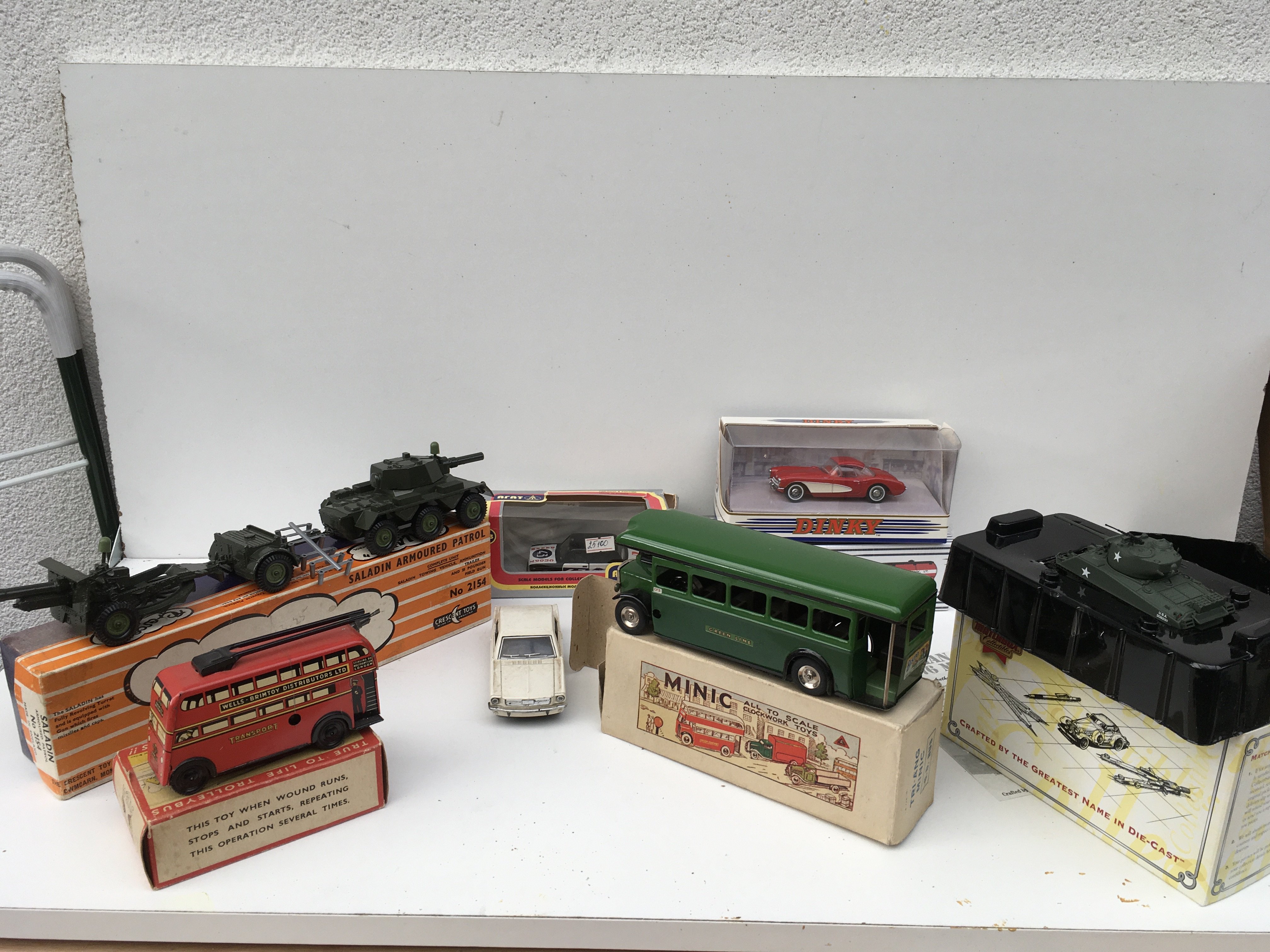 A mixed collection of 8 diecast and tinplate model vehicles 7 in their original packaging. Manufacturers include Arat ..Dinky..Crescent..Matchbox..Triang minic..Wells etc.