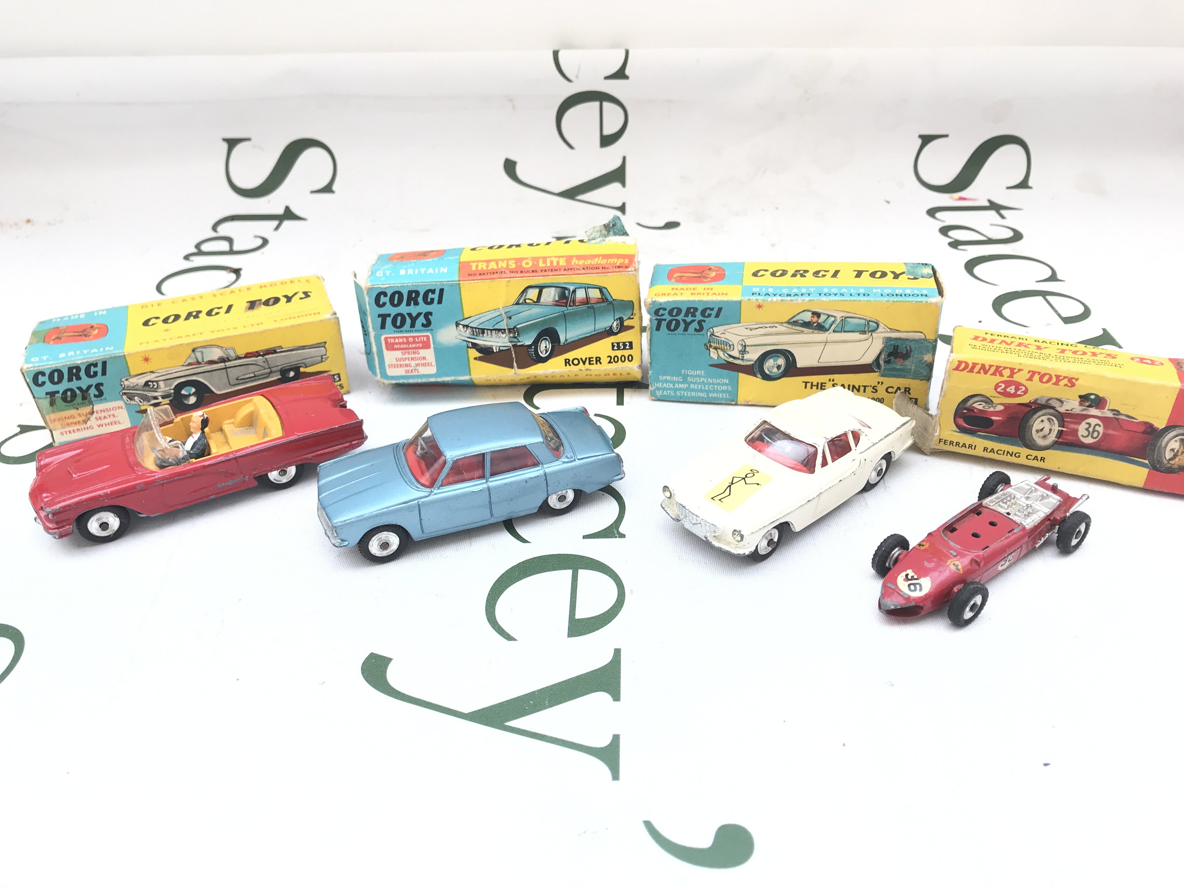 A Boxed Corgi Ford Thunderbird-Open Sports #2155 a Rover 2000 #252. The Saints Car #258 And A Dinky Ferrari Racing Car #242 parts Missing #242. Boxes Are Worn.