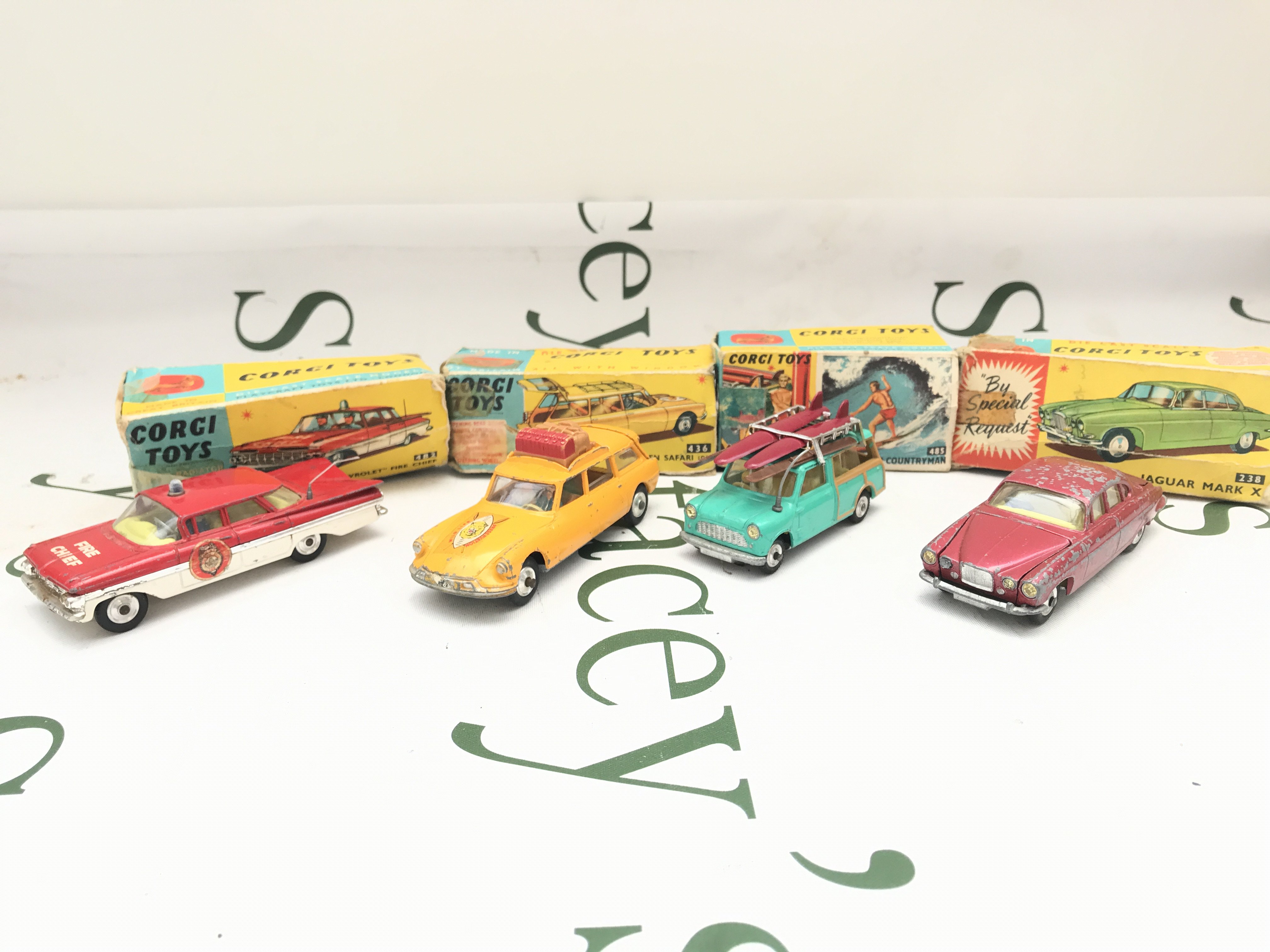 4 Boxed Corgi Vehicles. A Chevrolet Fire Chief #482. A Citroen Safari (playworn) #436. A B.M.C Mini Countryman #485 And A Jaguar Mark x (Play Worn) #238. Boxes Are Worn.