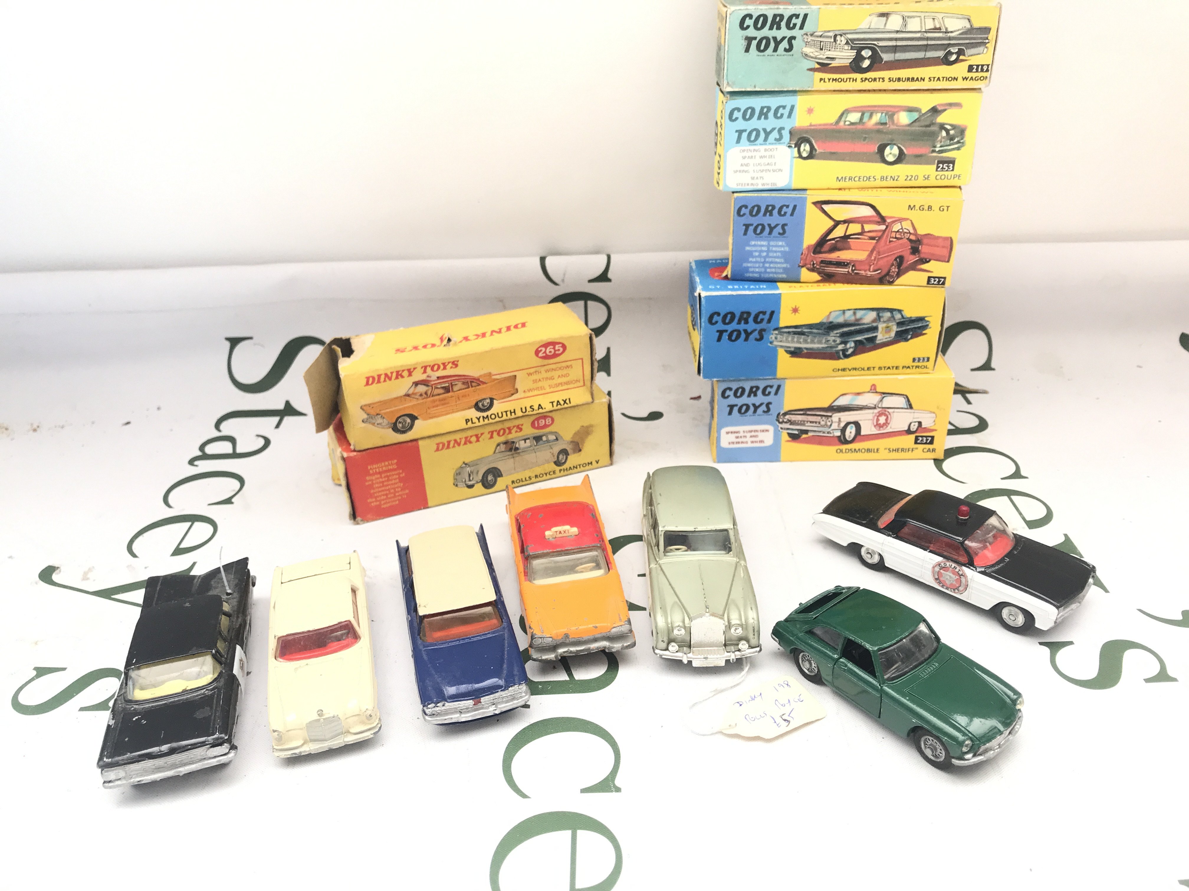 A Collection of Boxed Corgi Diecast In Repro Boxes And 2 Dinky Cars In Original Boxes. No Reserve.