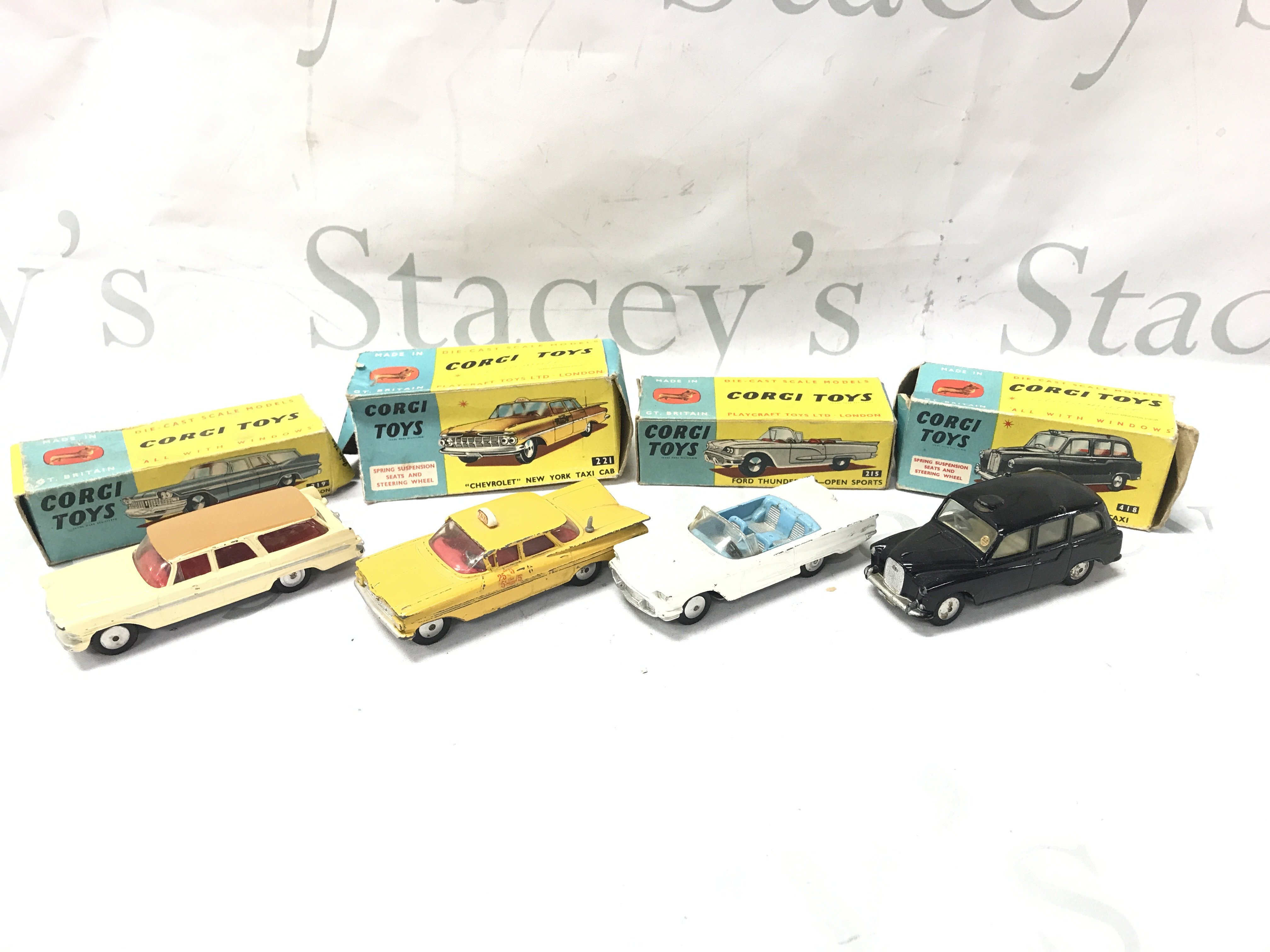 4 X Boxed Corgi Vehicles. A Plymouth Sorts Suburban #219 A Chevrolet New York Taxi Cab #221. A Ford Thunderbird-Open Sports #215 And A Austin Taxi #418. Boxes Are Worn. Cars Are Playworn. No Reserve.